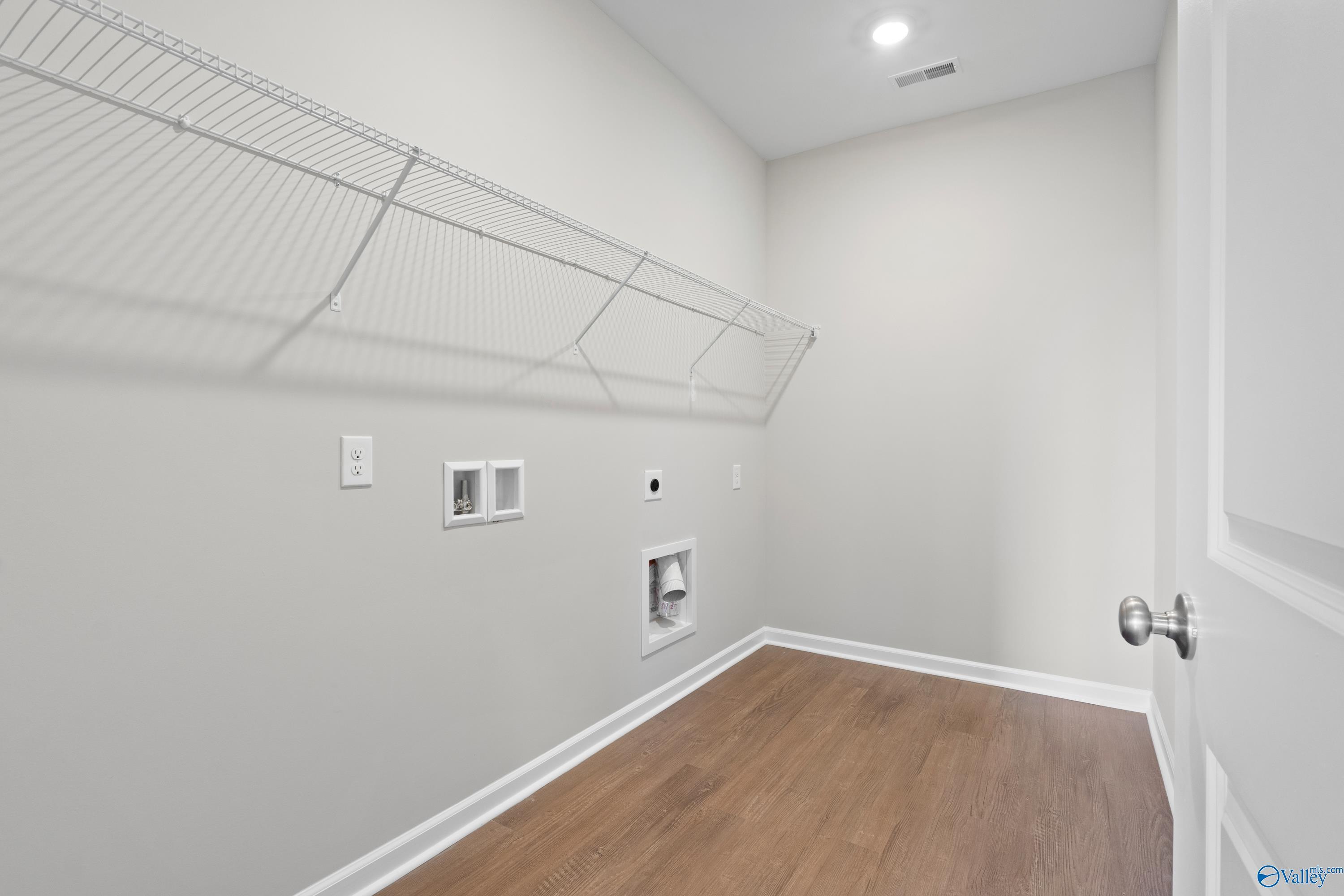 Spacious laundry room with wire shelving and washer/dryer hookups in Davidson Homes The Dorado, Athens, Alabama