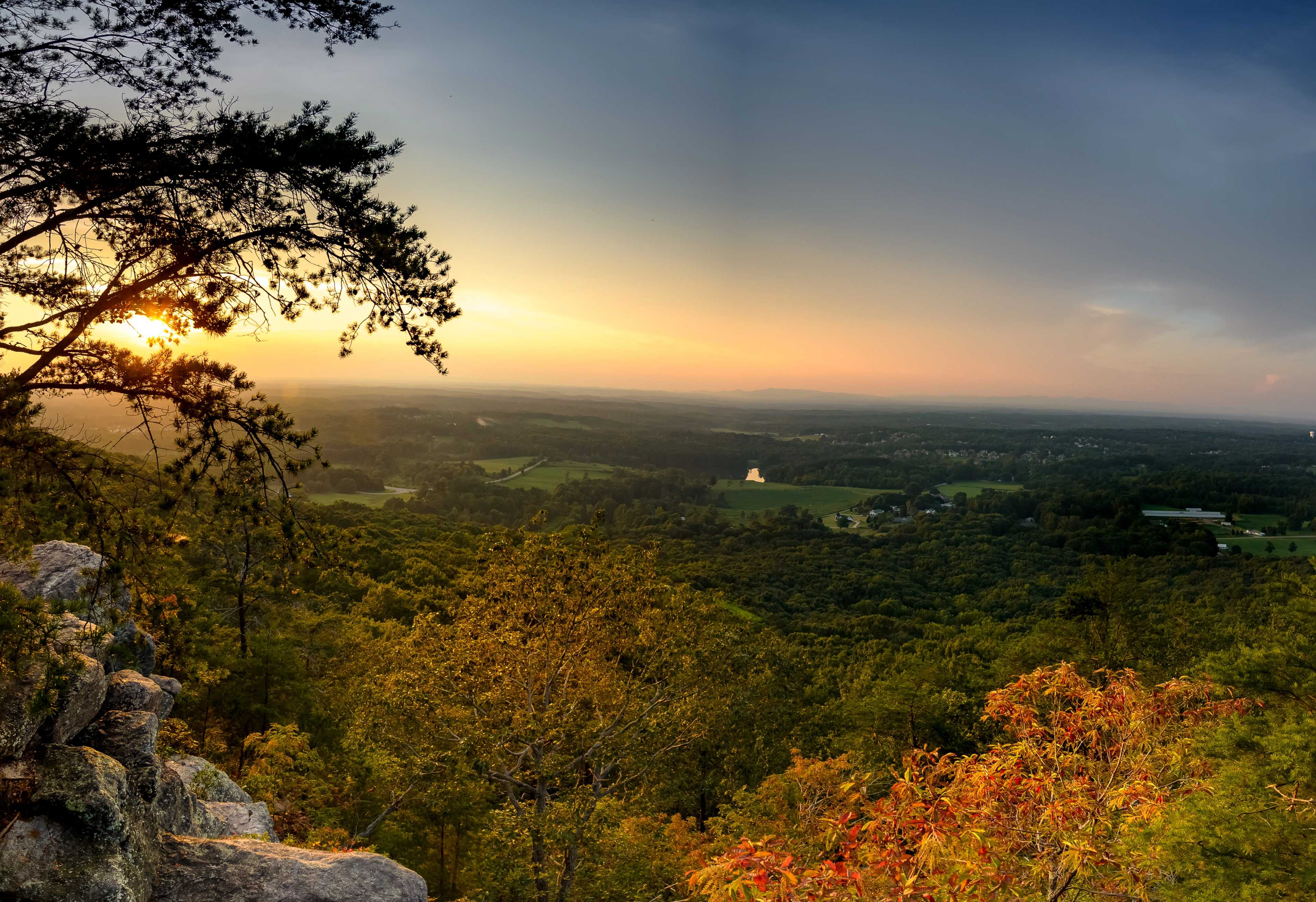 Scenic autumn sunset from rocky overlook at Hemingway in Cumming Georgia with vibrant foliage and rolling valleys