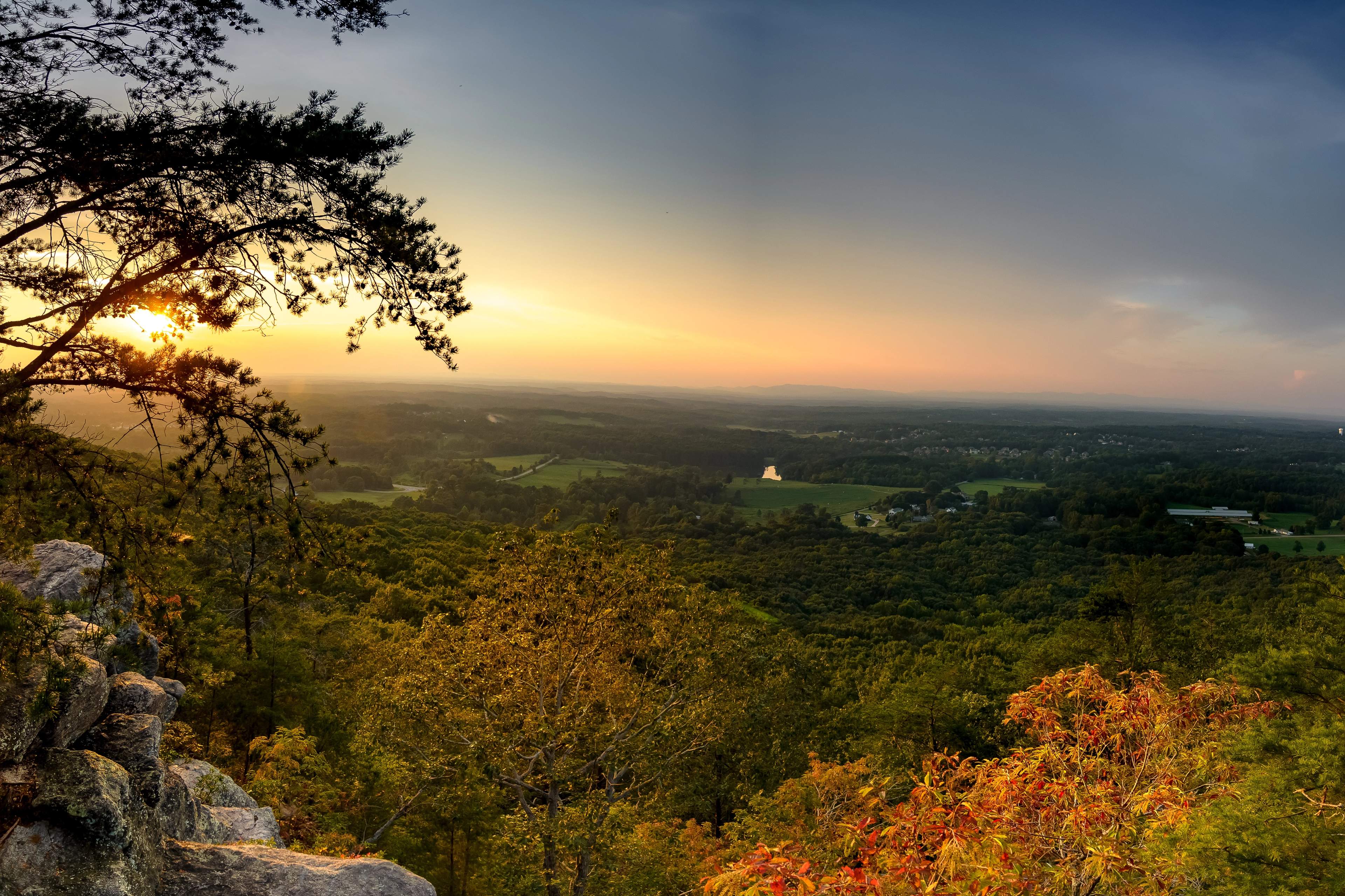 Scenic autumn sunset from rocky overlook at Hemingway in Cumming Georgia with vibrant foliage and rolling valleys