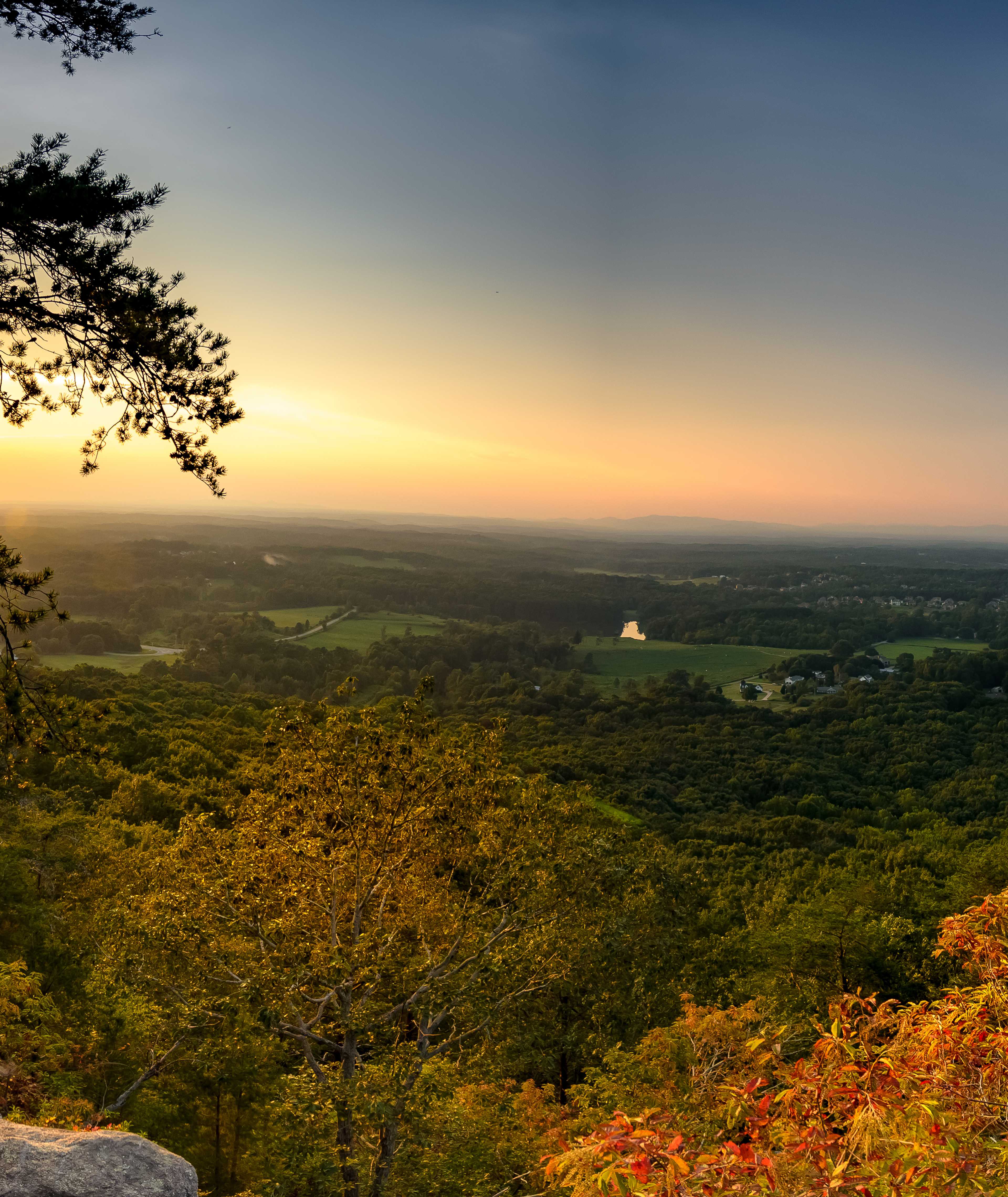 Scenic autumn sunset from rocky overlook at Hemingway in Cumming Georgia with vibrant foliage and rolling valleys