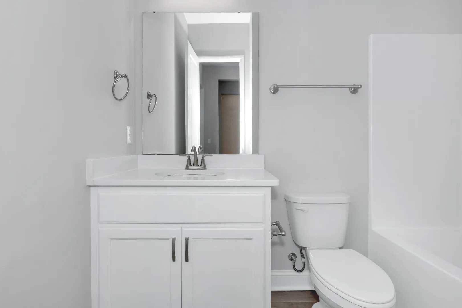 Spacious master bathroom in The Arcadia M with white double vanity, soaking tub, and modern fixtures by Evermore Homes