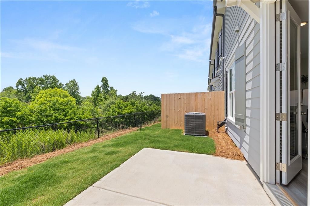 Concrete patio and backyard view at The Wake B floor plan by Davidson Homes in Hemingway, Cumming, Georgia.