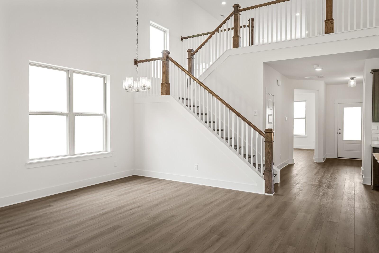 Two-story foyer with hardwood floors and grand staircase in The Ridgeport C floor plan, Woods Crossing, Gallatin, TN.