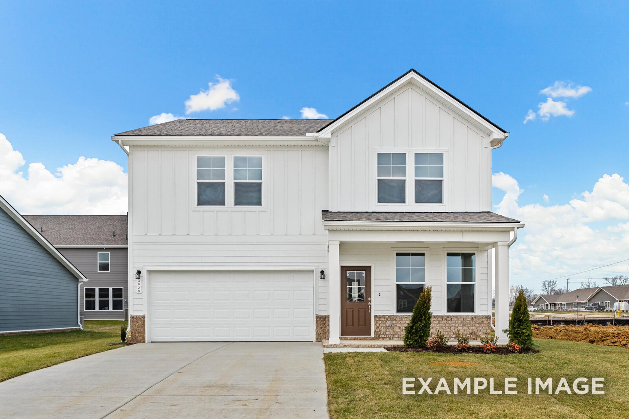 Two-story The Logan C home design with white board-and-batten siding, covered front porch, two-car garage, and landscaped yard in White House, TN