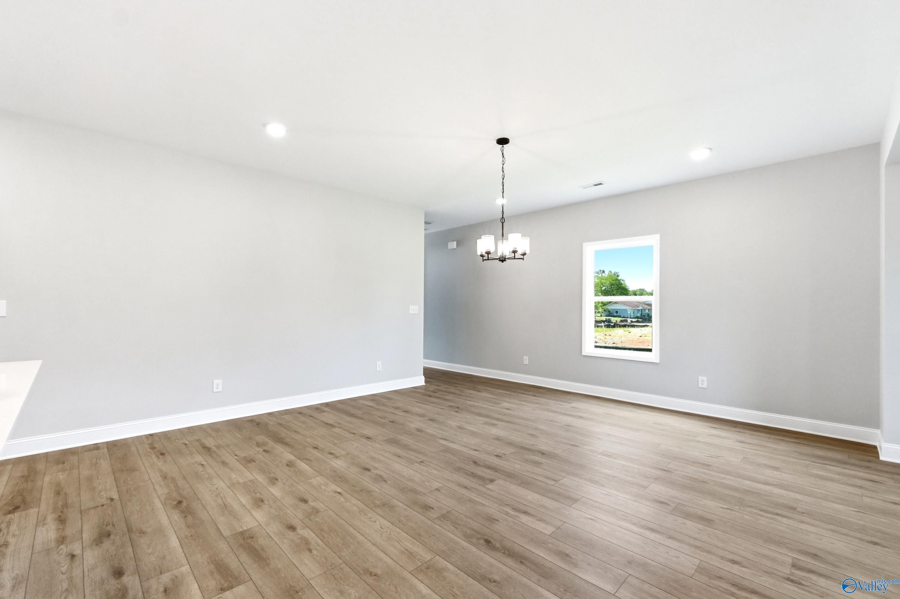 Bright and open dining area with modern chandelier in The Russell A floor plan by Davidson Homes in Huntsville, Alabama.