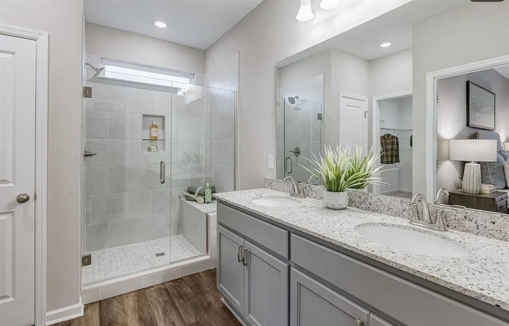 Master bathroom with double vanity, granite countertops, and walk-in tile shower in Davidson Homes Aurora D, Opelika, Alabama