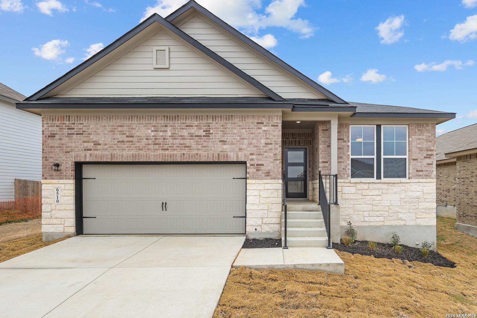 Modern brick single-story home with 2-car garage, covered porch, and stone accents in Royal Crest, San Antonio, Texas