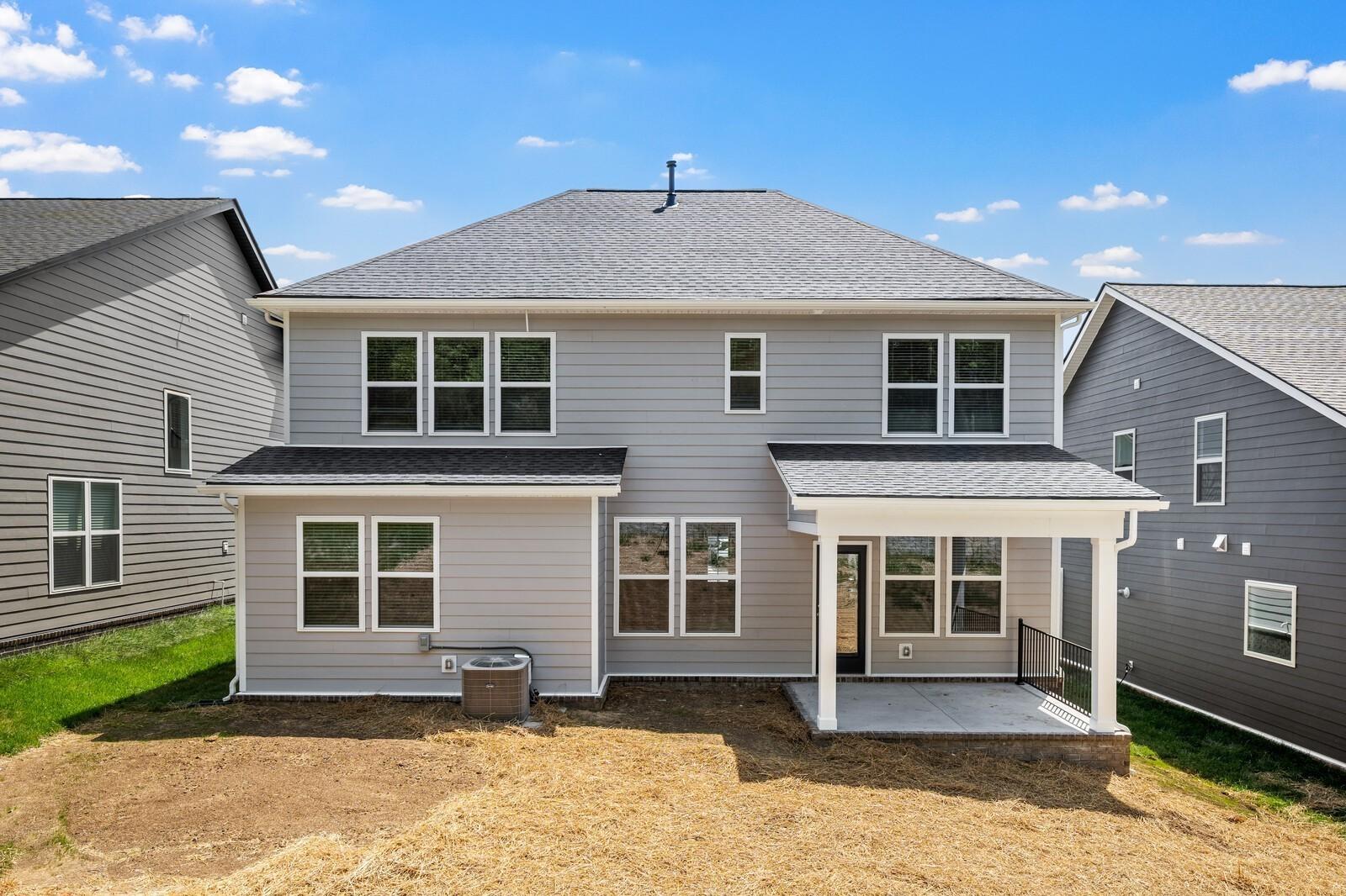Back exterior view of The Willow floor plan by Davidson Homes in Woods Crossing, Gallatin, Tennessee with covered patio.