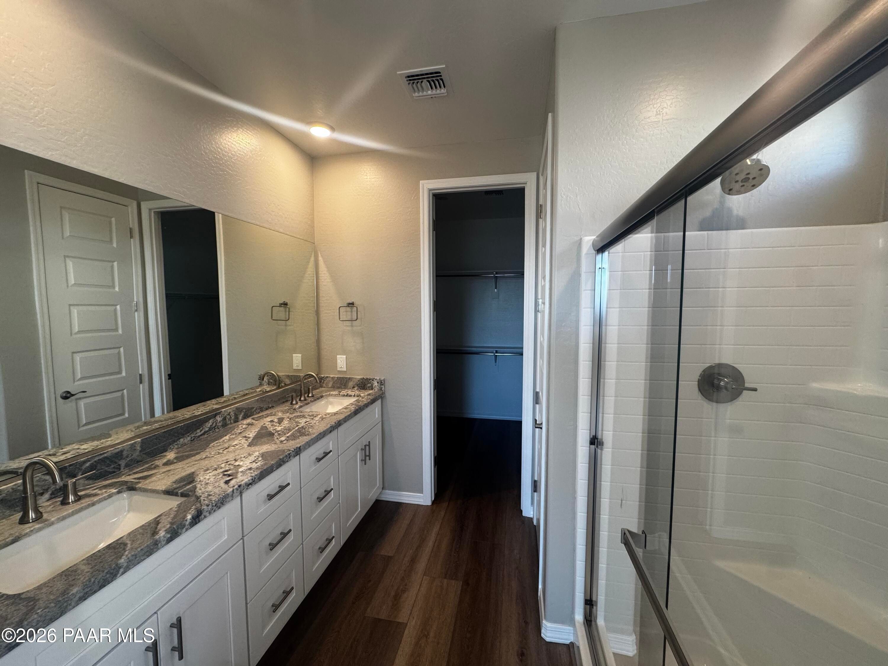 Modern master bathroom featuring dual sinks, quartz vanity, walk-in glass shower in Davidson Homes Daybreak B, Prescott AZ