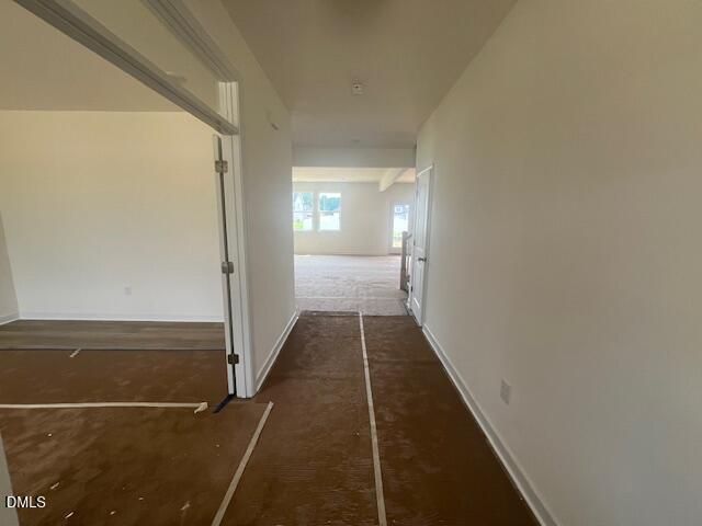 Bright foyer and hallway leading to an open-concept living area in The Hickory II B floor plan at Retreat at North Main.