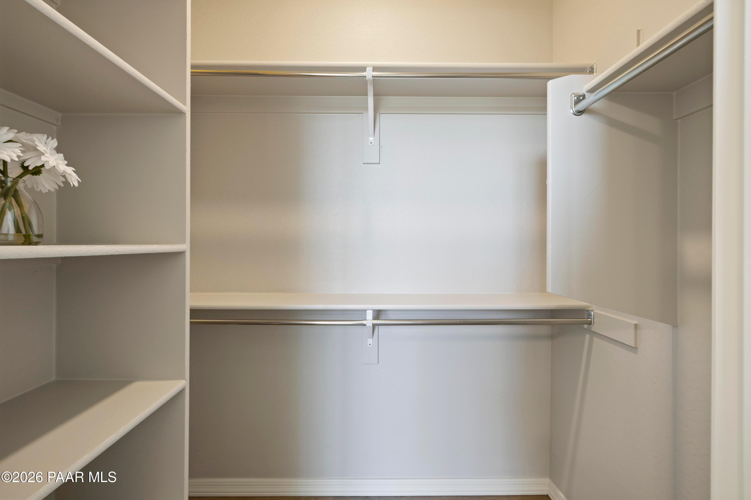 Walk-in closet with built-in shelving and hanging rods in The Harmony A plan at North Ridge, Prescott Valley, Arizona.
