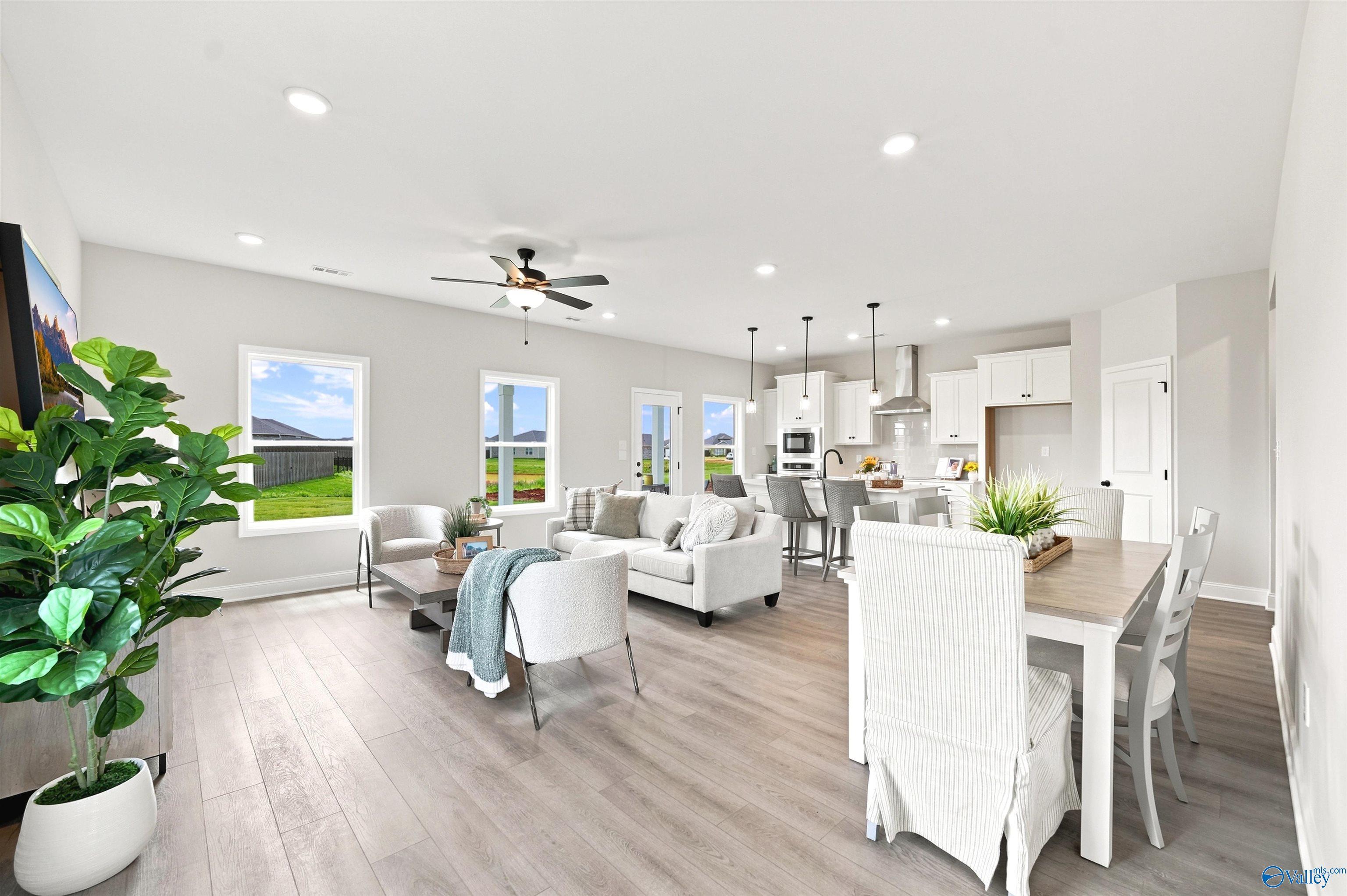 Open-concept living room and kitchen in The Burton B floor plan at Heritage Lakes, New Market, Alabama.