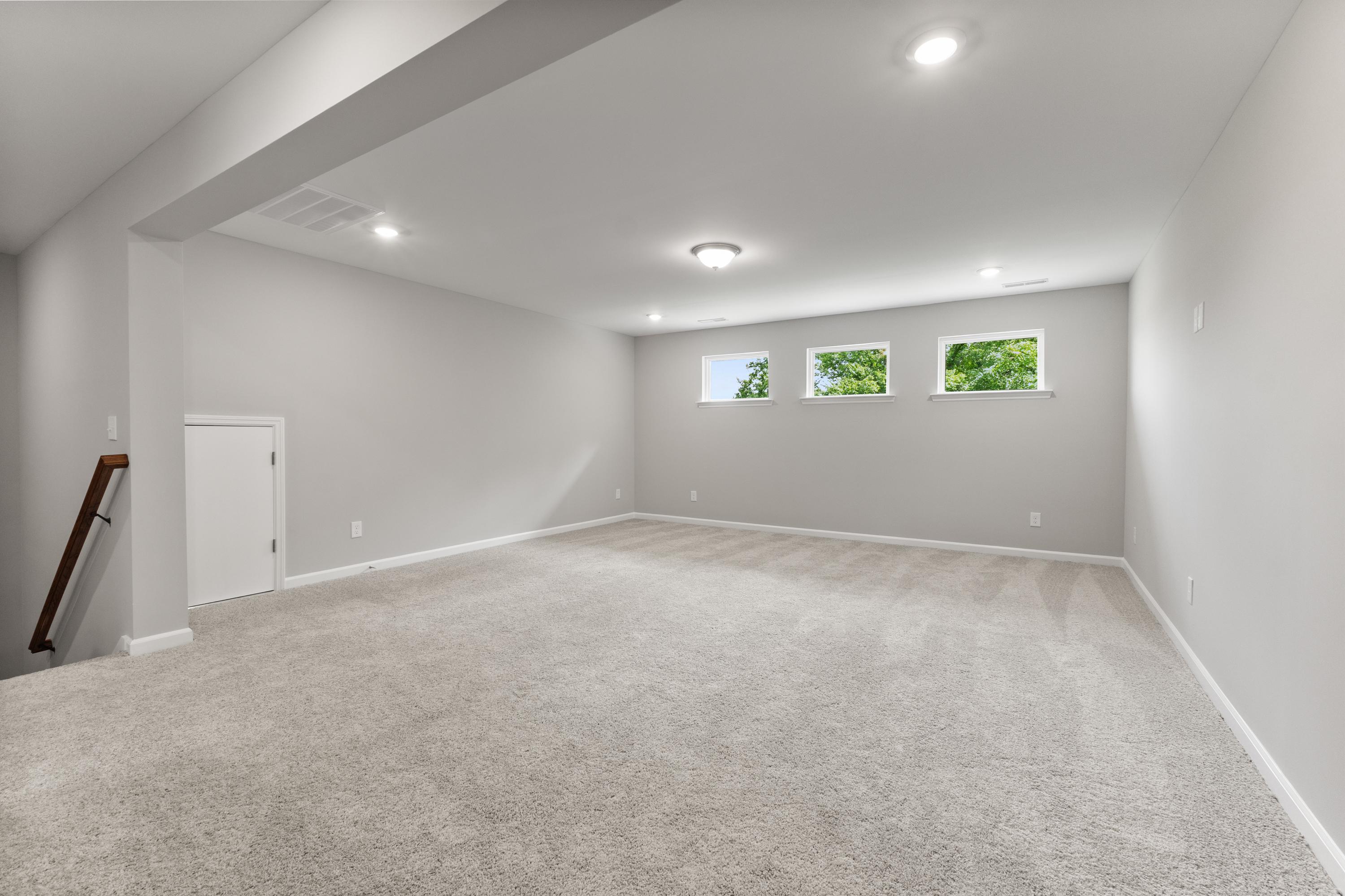 Spacious upstairs bonus room in The Avalon D with gray walls, carpeted floor, three clerestory windows, and open layout