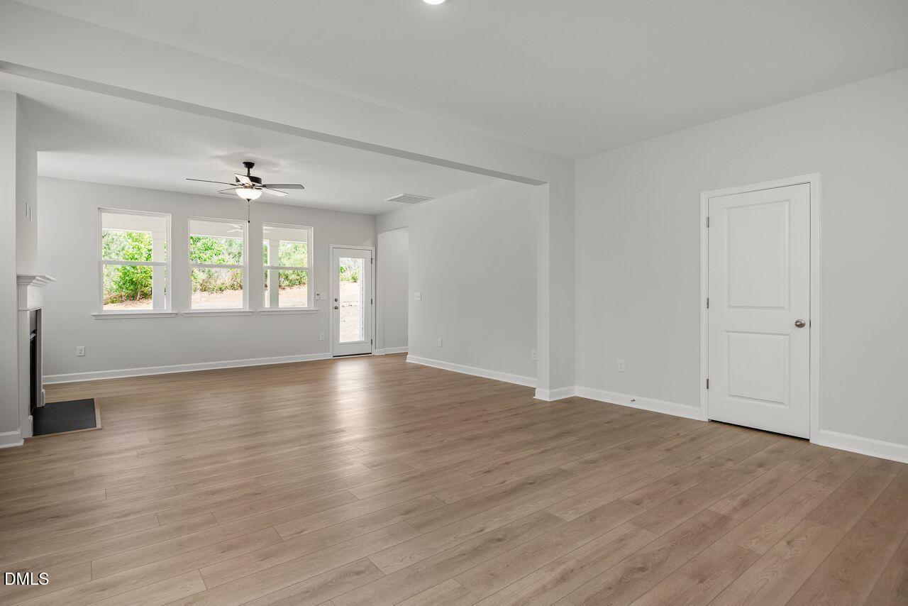 Spacious open-concept living room with wood-style flooring in The Birch II A home by Davidson Homes in Montrose, Aberdeen.