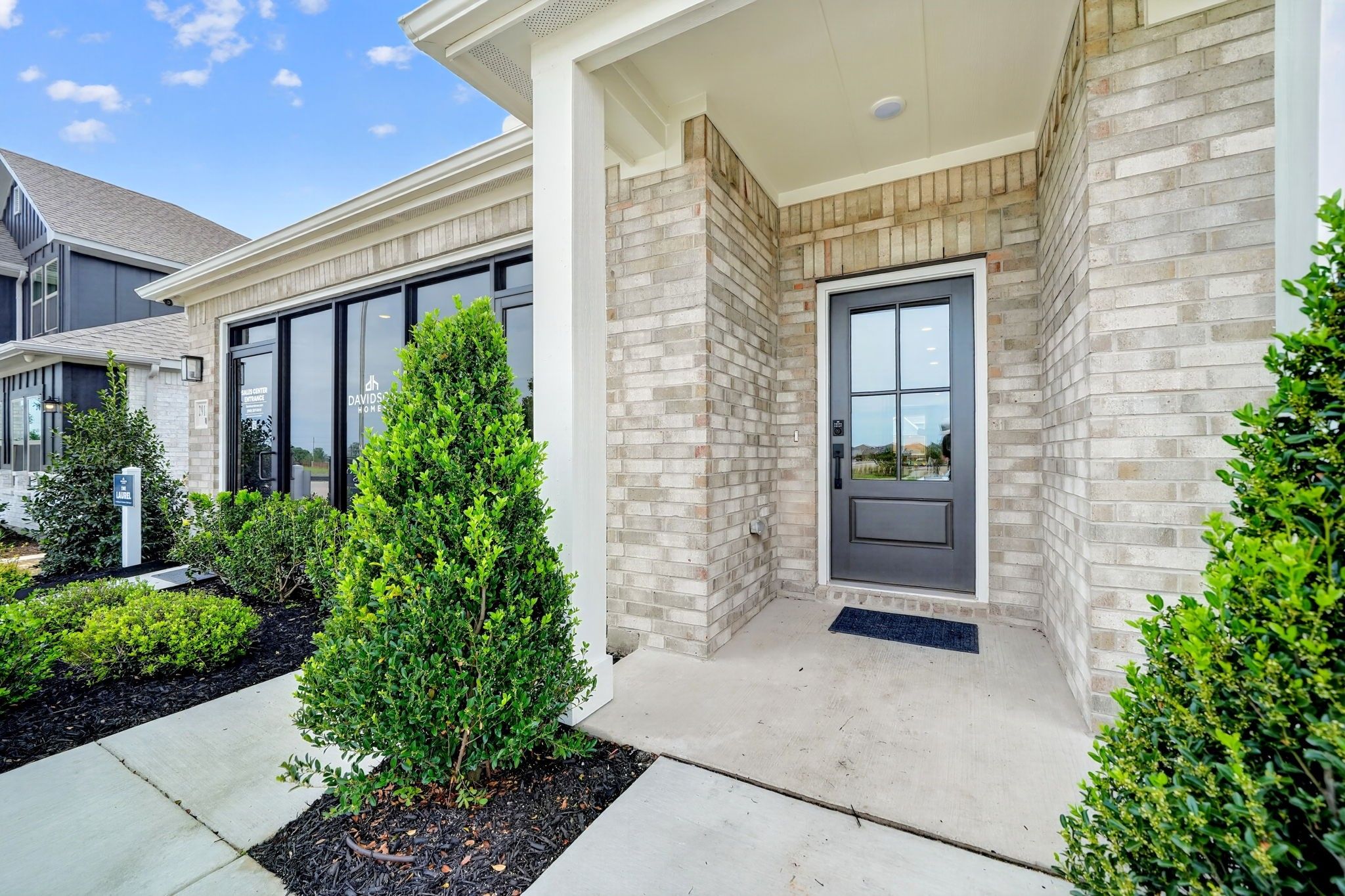 Brick exterior and front entrance of a Davidson Homes The Laurel I floor plan home in Heartland, Texas.