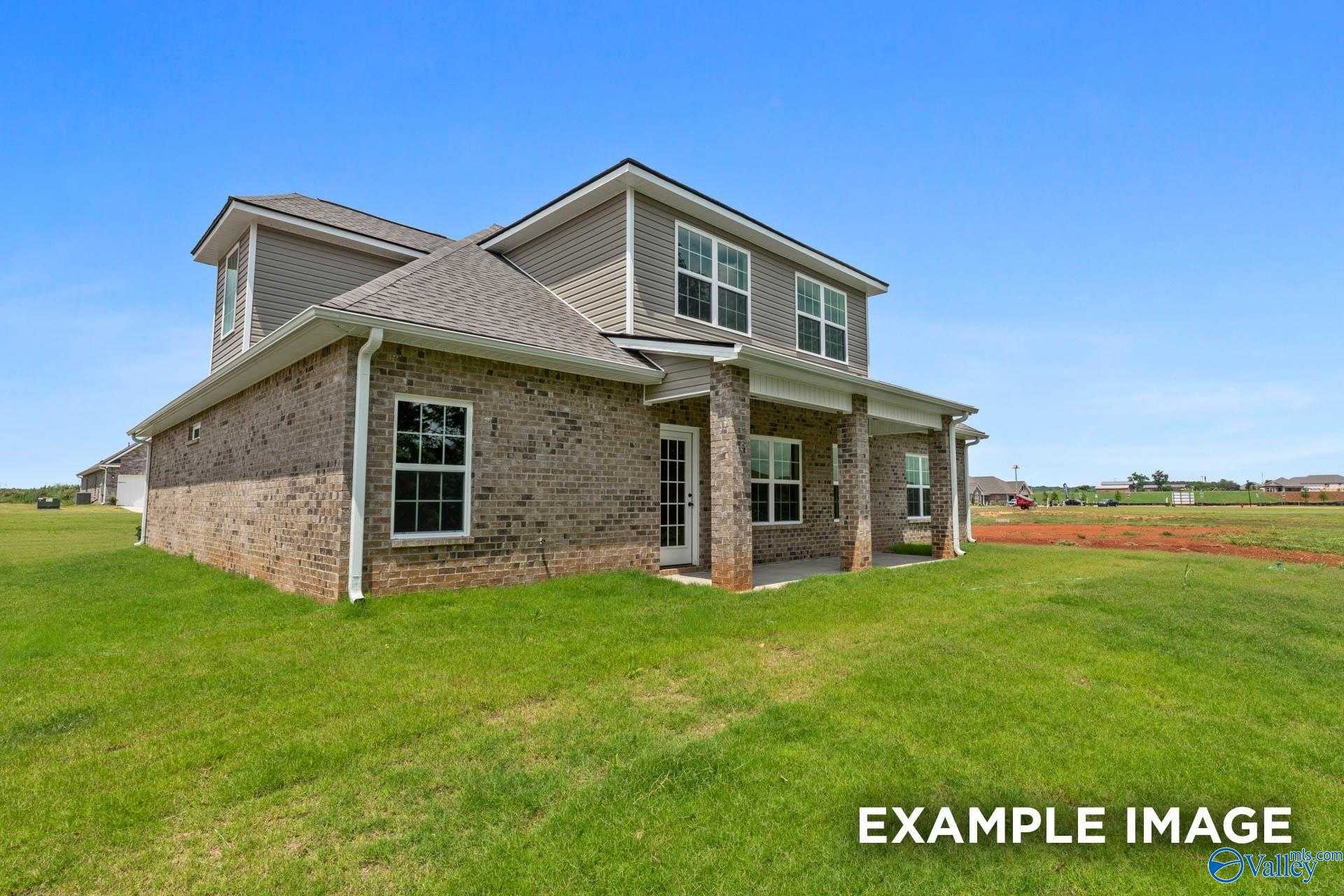 Brick single-story home with gray roof, covered porch, and lush green lawn in River Road Estates, Decatur, Alabama - The Kirkland by Davidson Homes