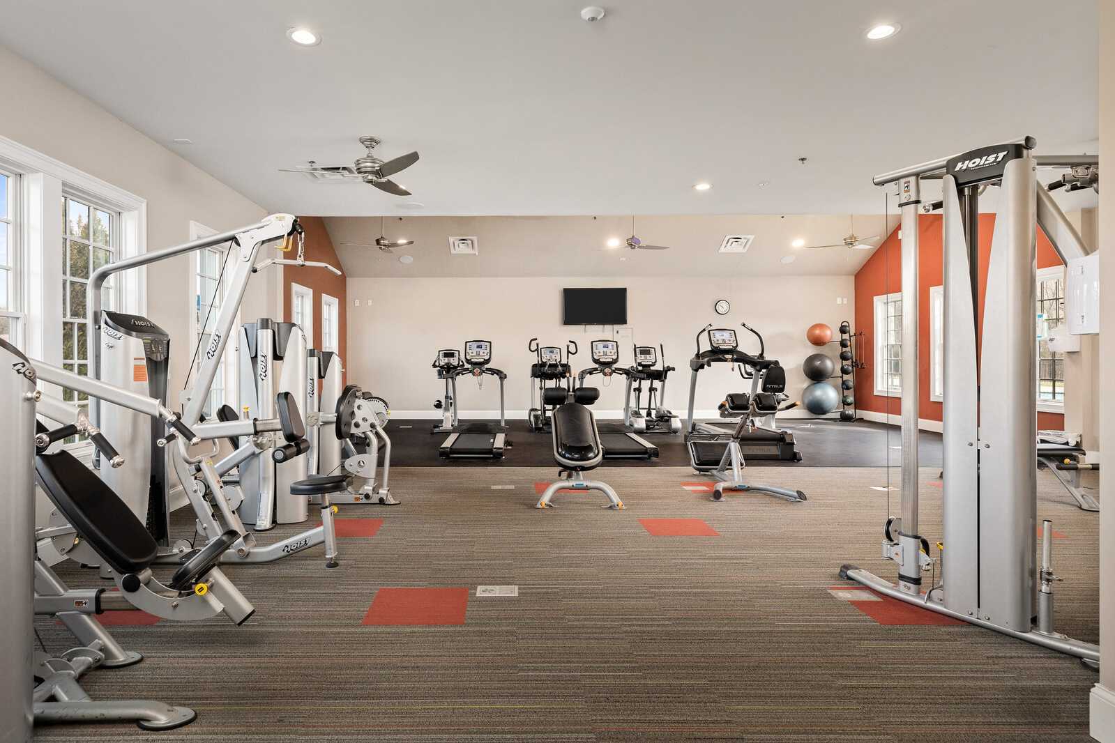 Modern fitness center at Carellton in Gallatin TN with treadmills, ellipticals, weight machines, and yoga balls