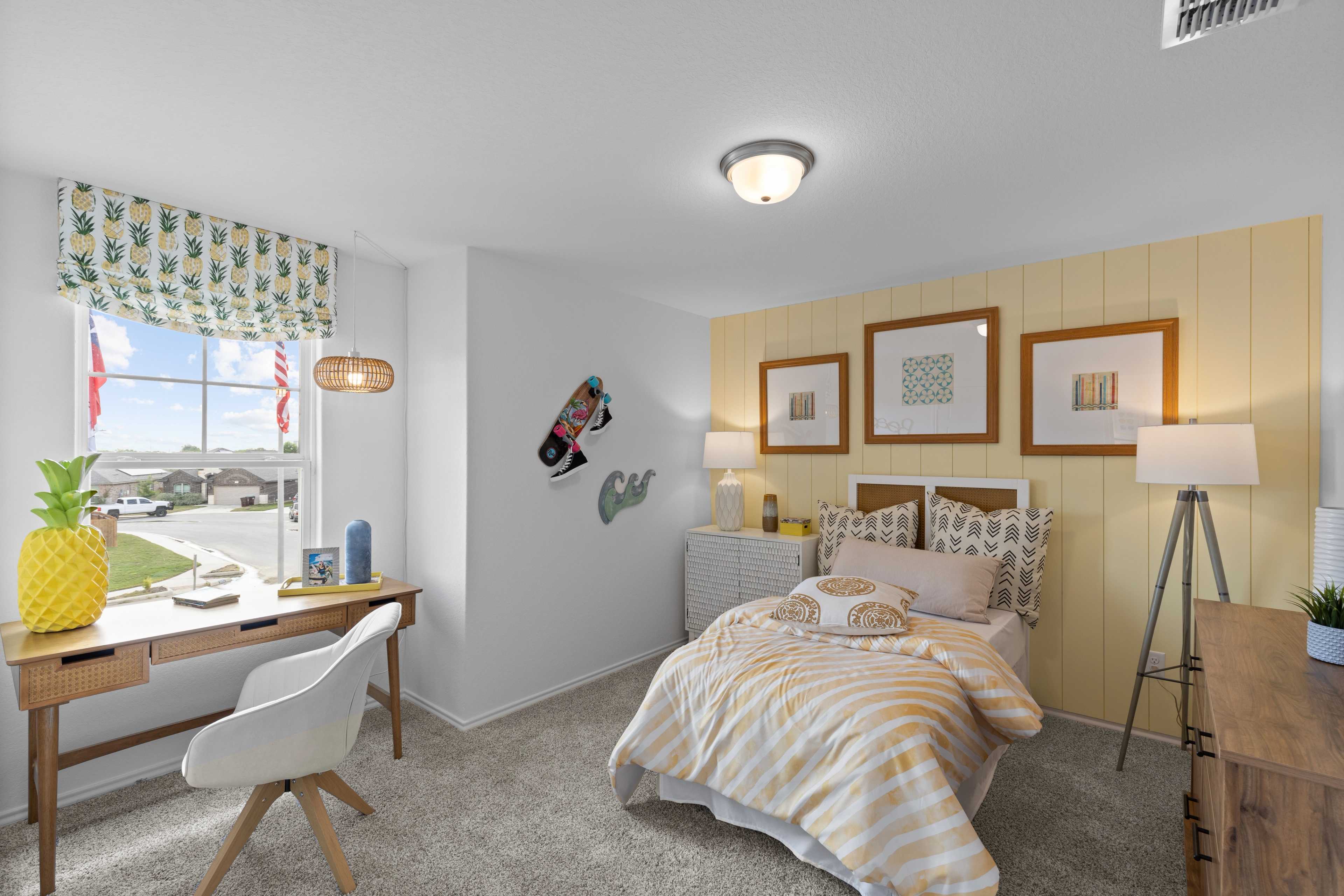 Vibrant kids bedroom at Horizon Pointe in Converse Texas with striped bed, wooden desk, pineapple plant, and colorful curtains