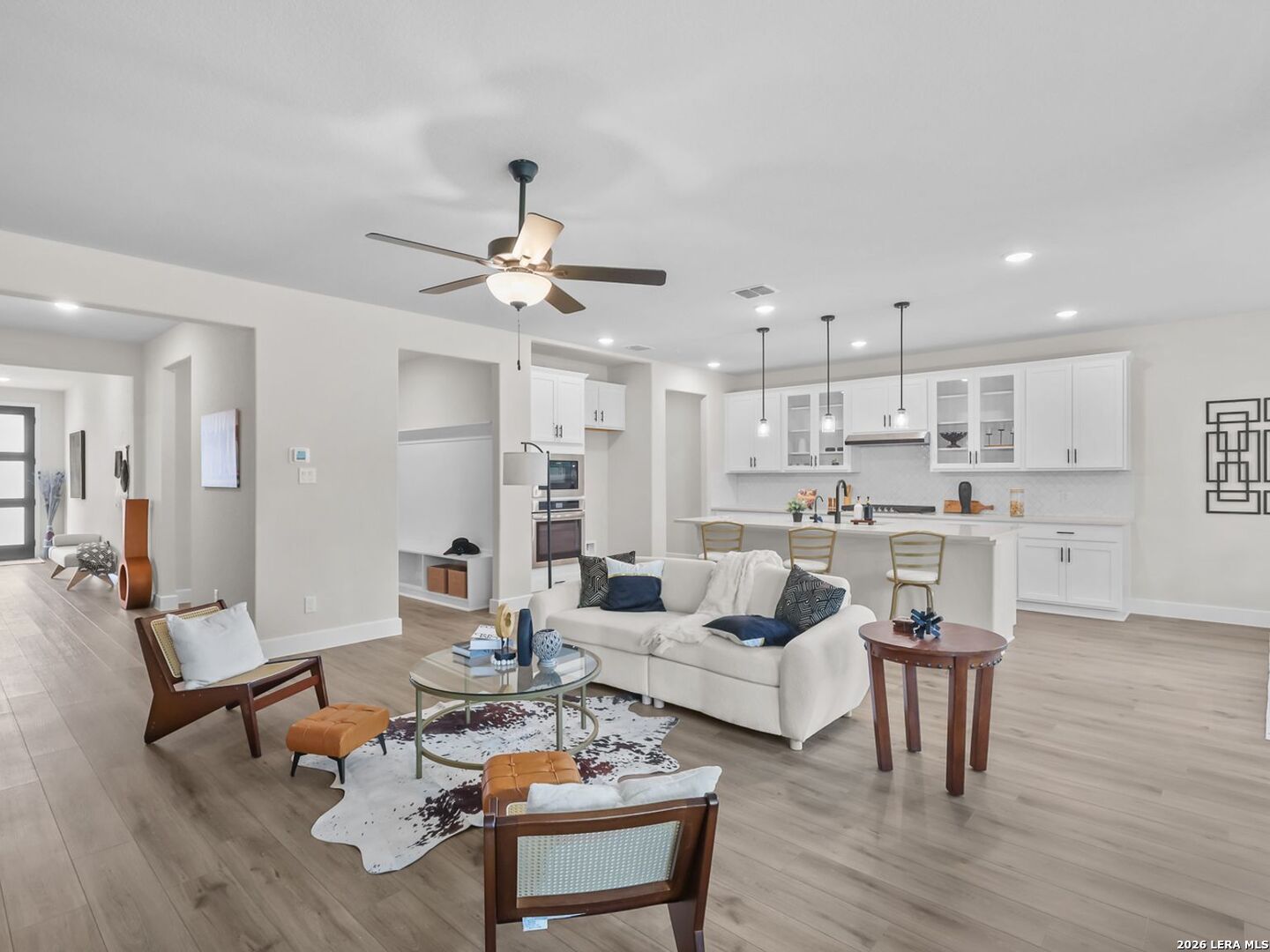 Open-concept living room and kitchen in Davidson Homes Belmont floor plan at Potranco Oaks, Castroville, Texas.