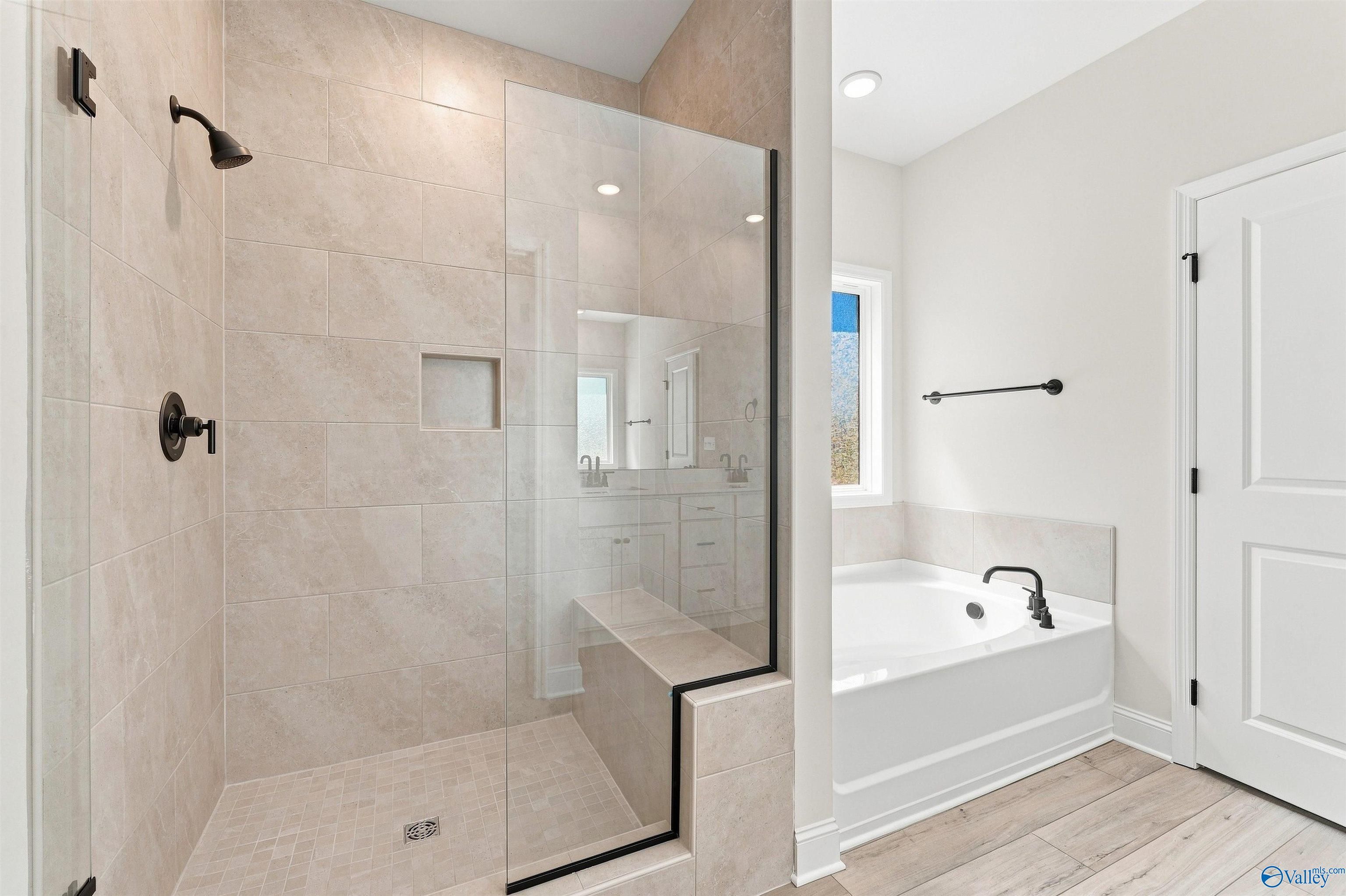 Modern master bathroom with glass walk-in shower and soaking tub in Davidson Homes The Everett B plan, Ivy Hills, Toney, Alabama