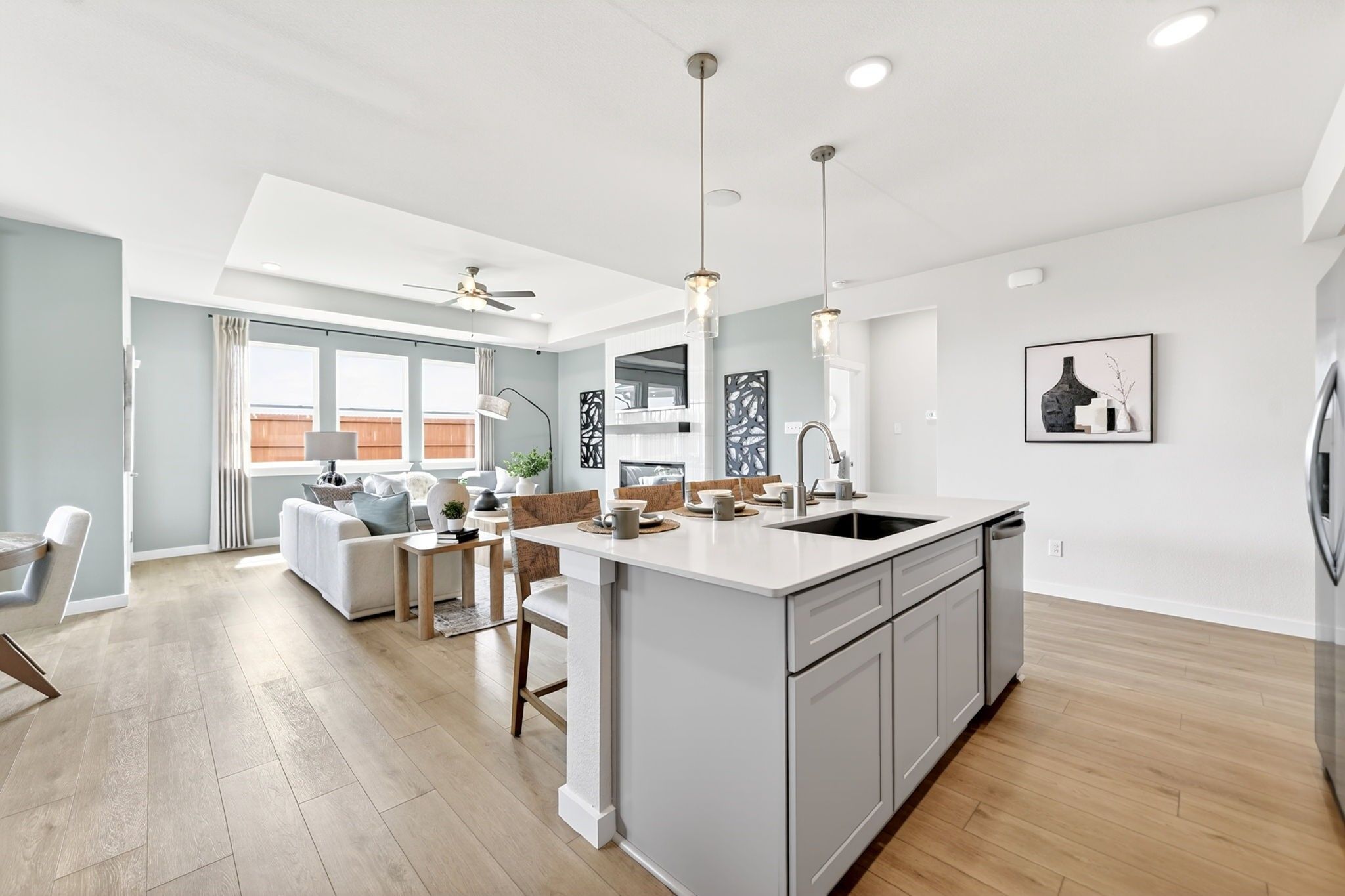 Open-concept kitchen and living area in The Laurel O floor plan by Davidson Homes in Parks at Foster Crossing, Anna, Texas