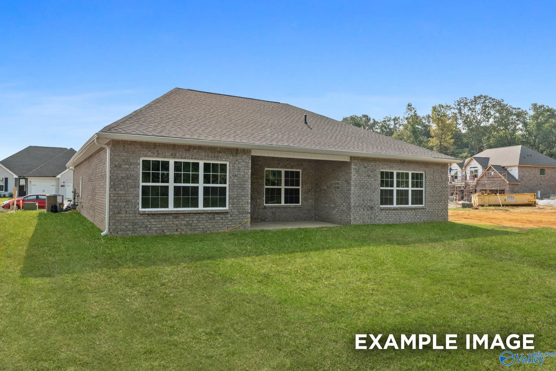 Brick exterior of The Montgomery B floor plan by Davidson Homes featuring a back patio in River Road Estates, Decatur, AL.