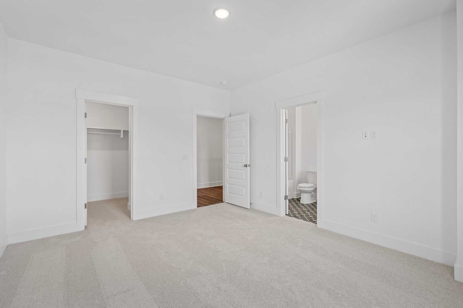 Bright secondary bedroom with walk-in closet and en-suite bath in Davidson Homes The Hawkins, Murfreesboro, TN