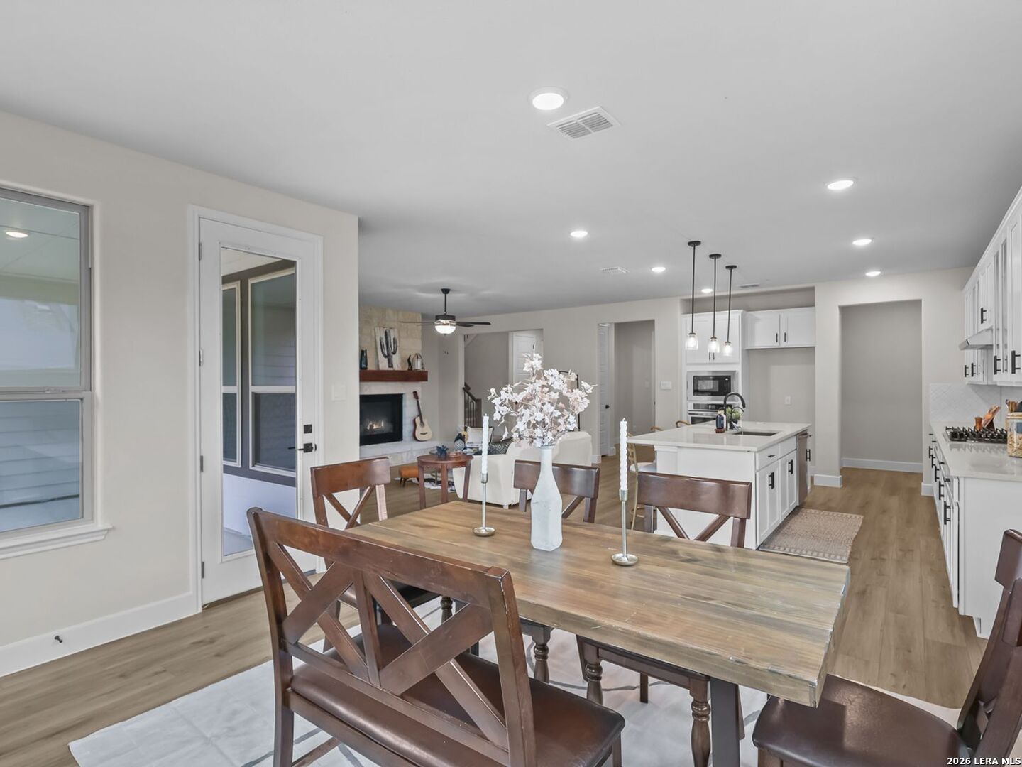 Open-concept dining area and kitchen in a Davidson Homes Belmont floor plan at Potranco Oaks, Castroville, Texas.
