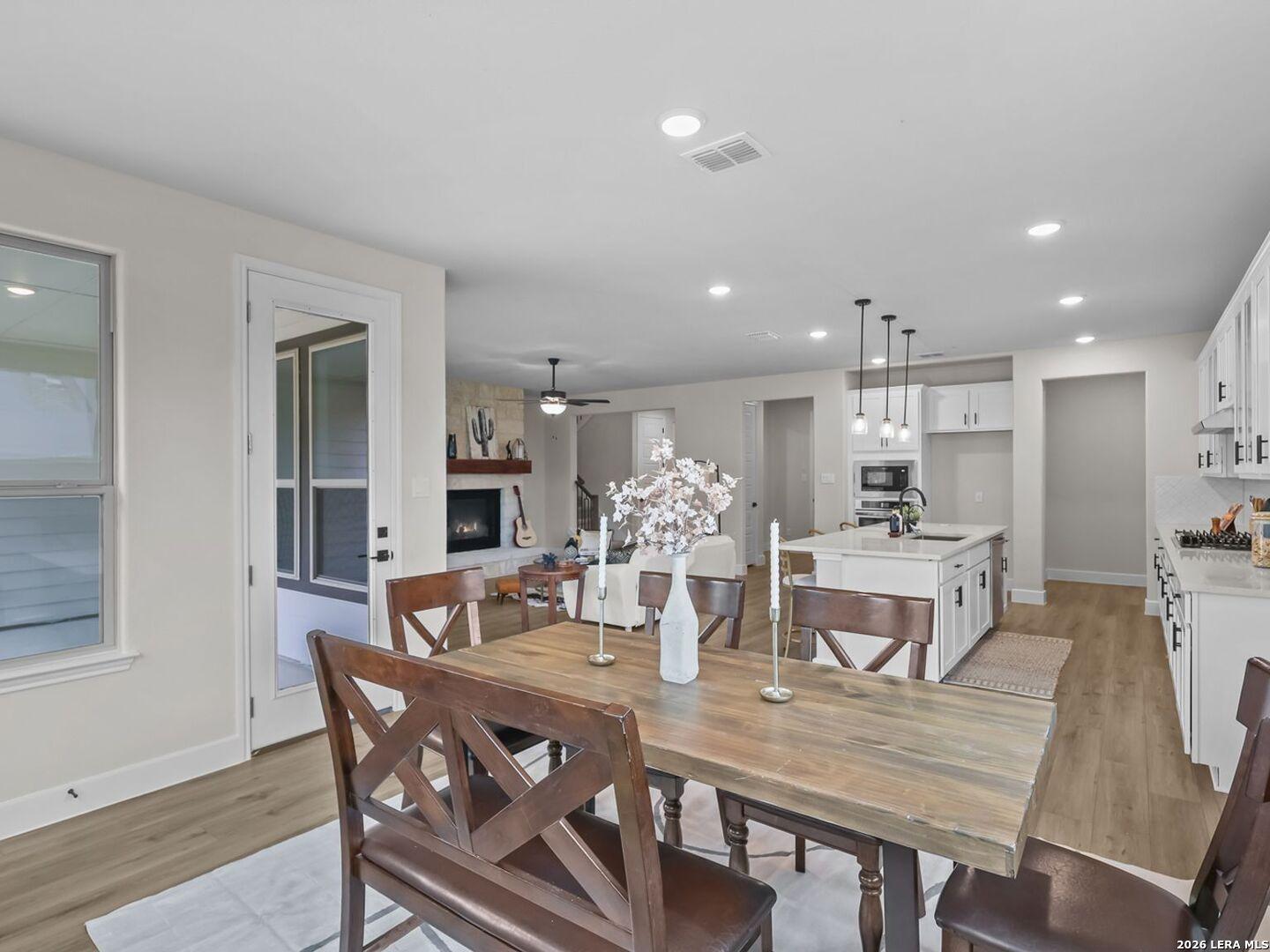 Open-concept dining area and kitchen in a Davidson Homes Belmont floor plan at Potranco Oaks, Castroville, Texas.