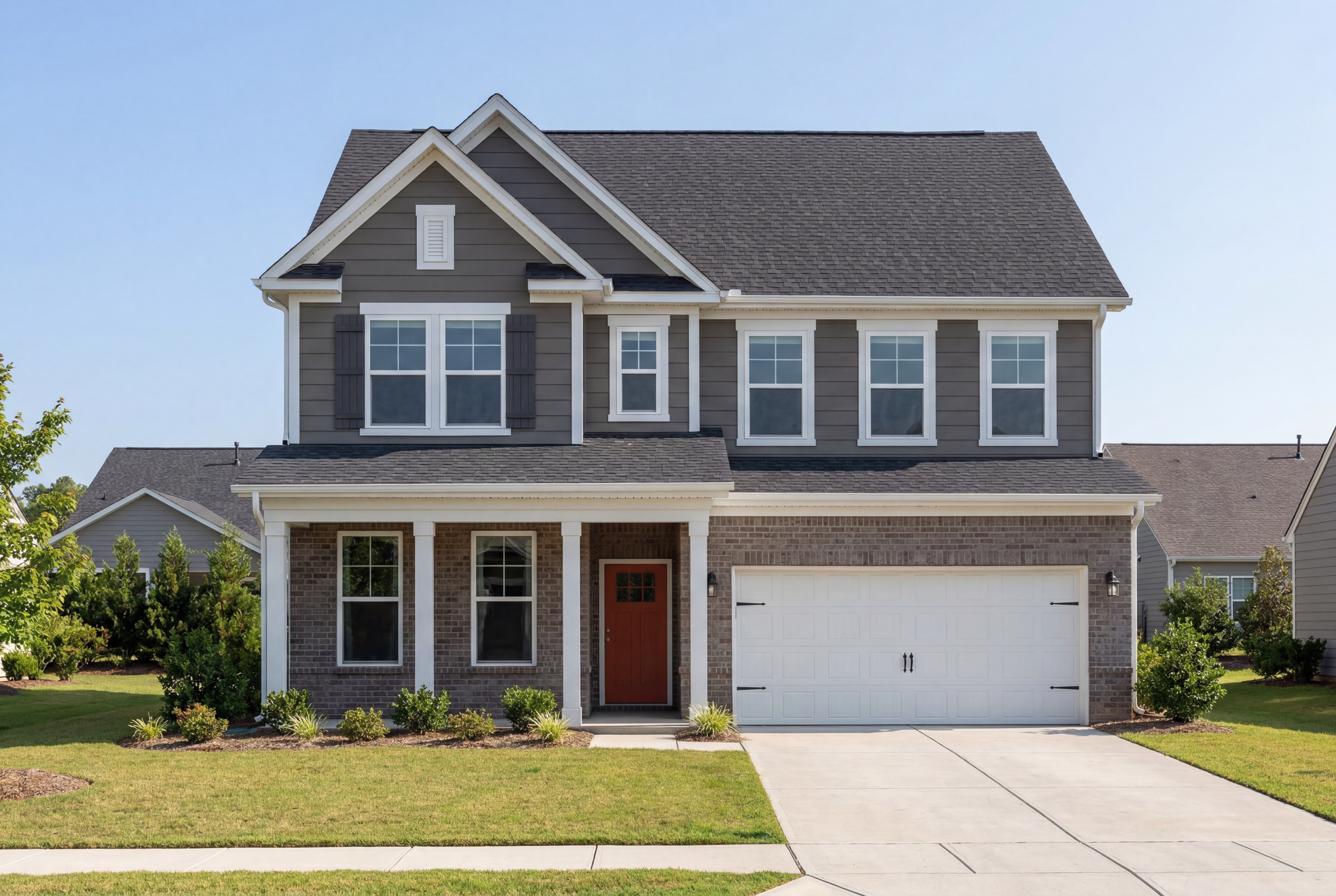 Modern two-story Chestnut C home exterior by Davidson Homes in Wendell NC with gray siding, red door, porch, and two-car garage