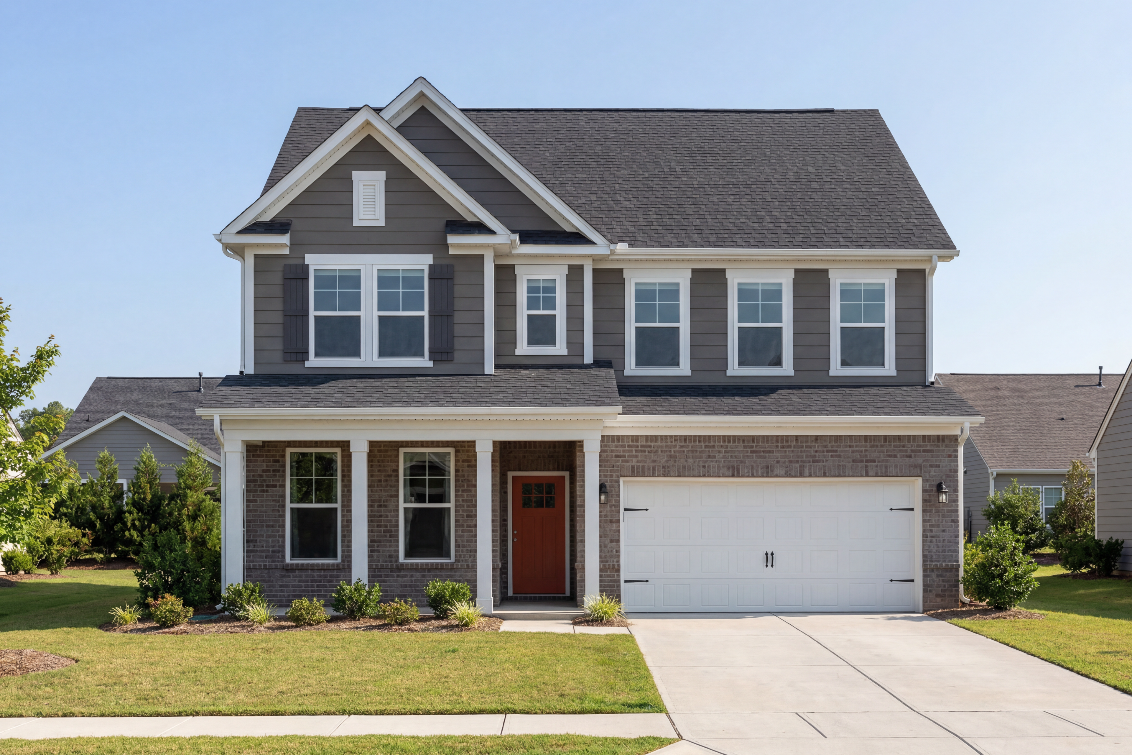Modern two-story Chestnut C home exterior by Davidson Homes in Wendell NC with gray siding, red door, porch, and two-car garage
