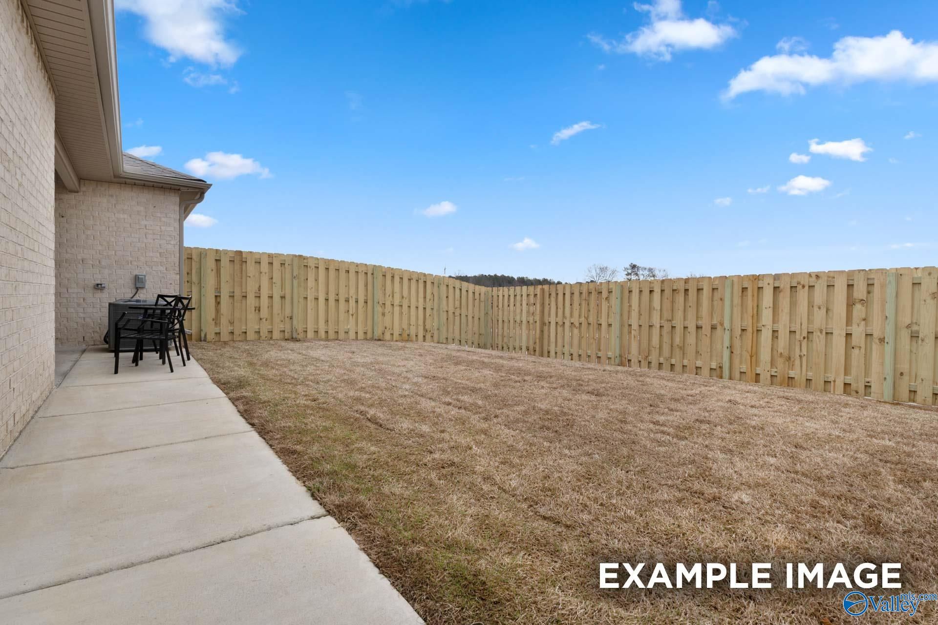 Fenced backyard with concrete patio and room to entertain at Davidson Homes' The Camilla C in The Retreat at Cain Park, Hartselle, AL