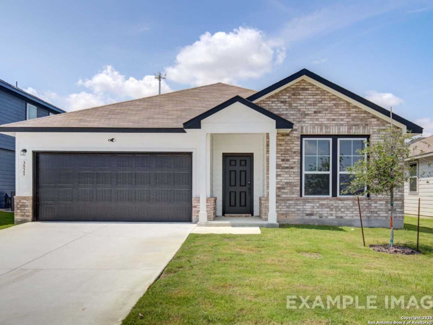 Modern single-story brick home with 2-car garage, black door, driveway, and lush lawn in Bricewood, San Antonio, Texas