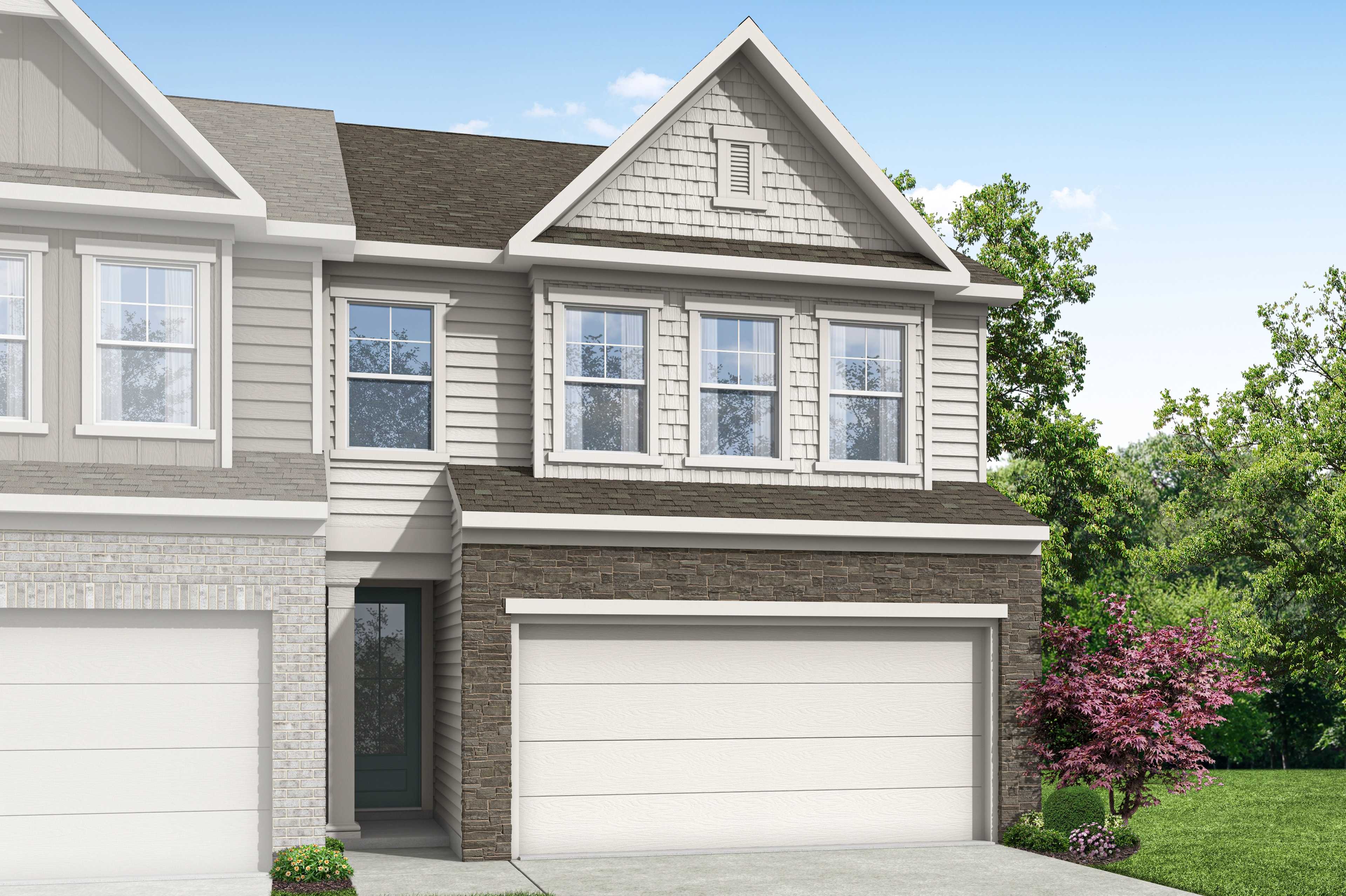 Craftsman-style home exterior at Lake Shore in Winder, Georgia with brick accents, covered porch and lush landscaping