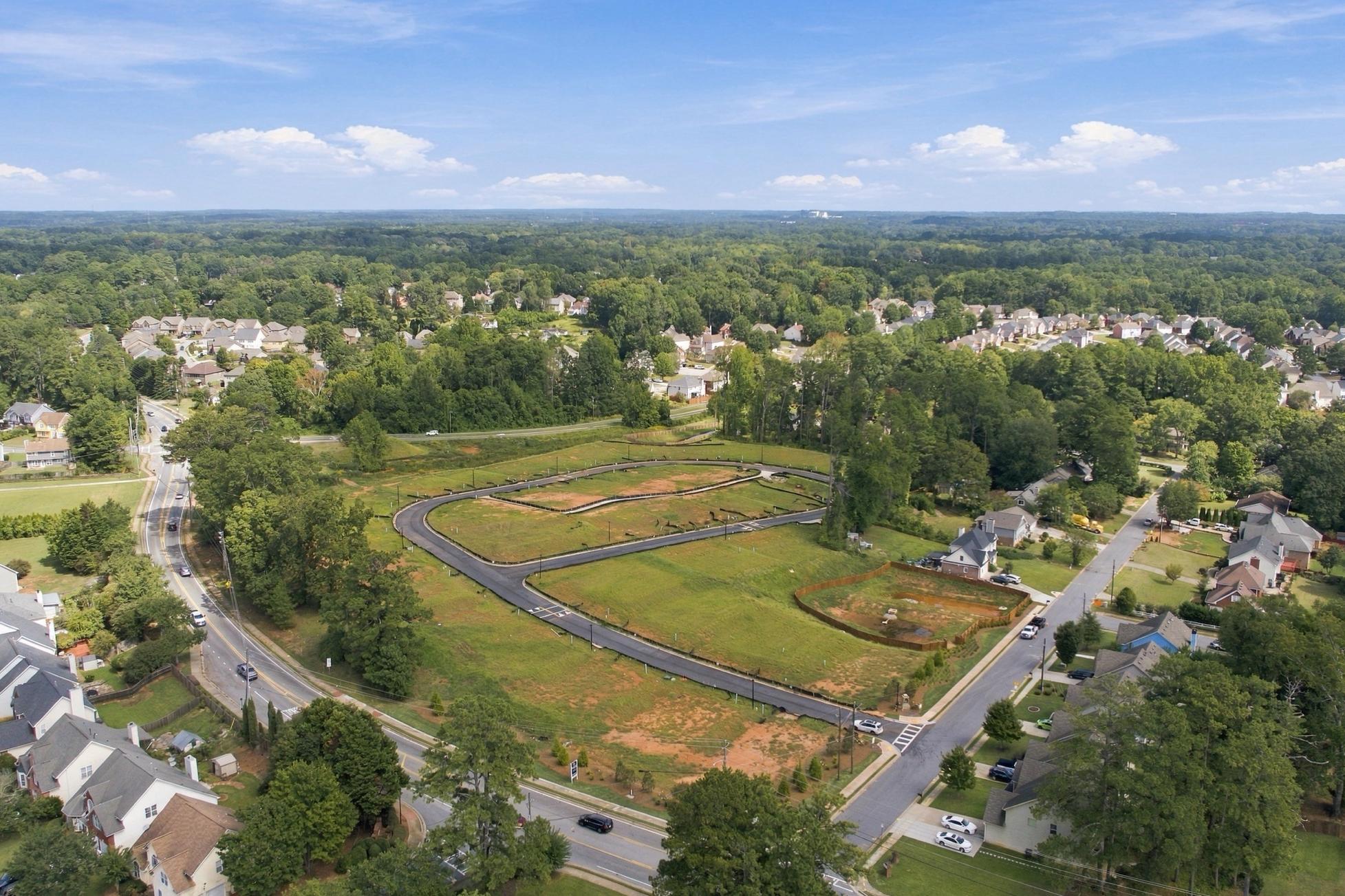 Aerial view of Alford at Bethesda community site in Lawrenceville, Georgia by Davidson Homes with new streets and surrounding neighborhood