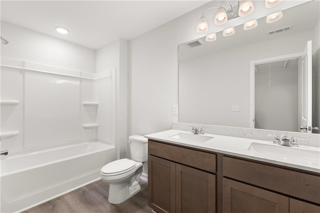 Modern bathroom with dual vanity and tub-shower combo in The Sinclair B floor plan by Davidson Homes in Winder, Georgia.