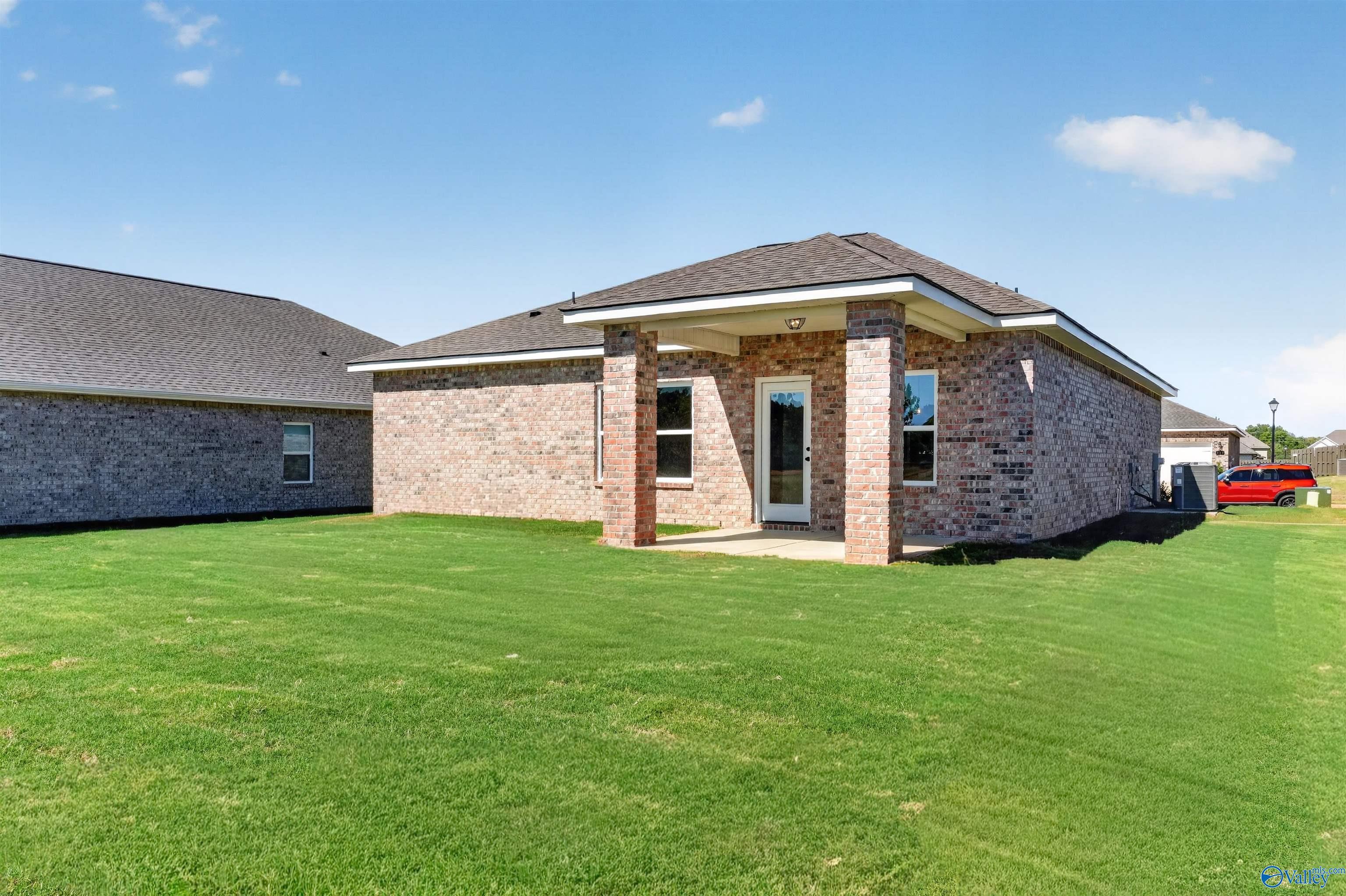 Brick single-story home with covered porch and large green backyard in Clearview, Hazel Green, Alabama by Davidson Homes