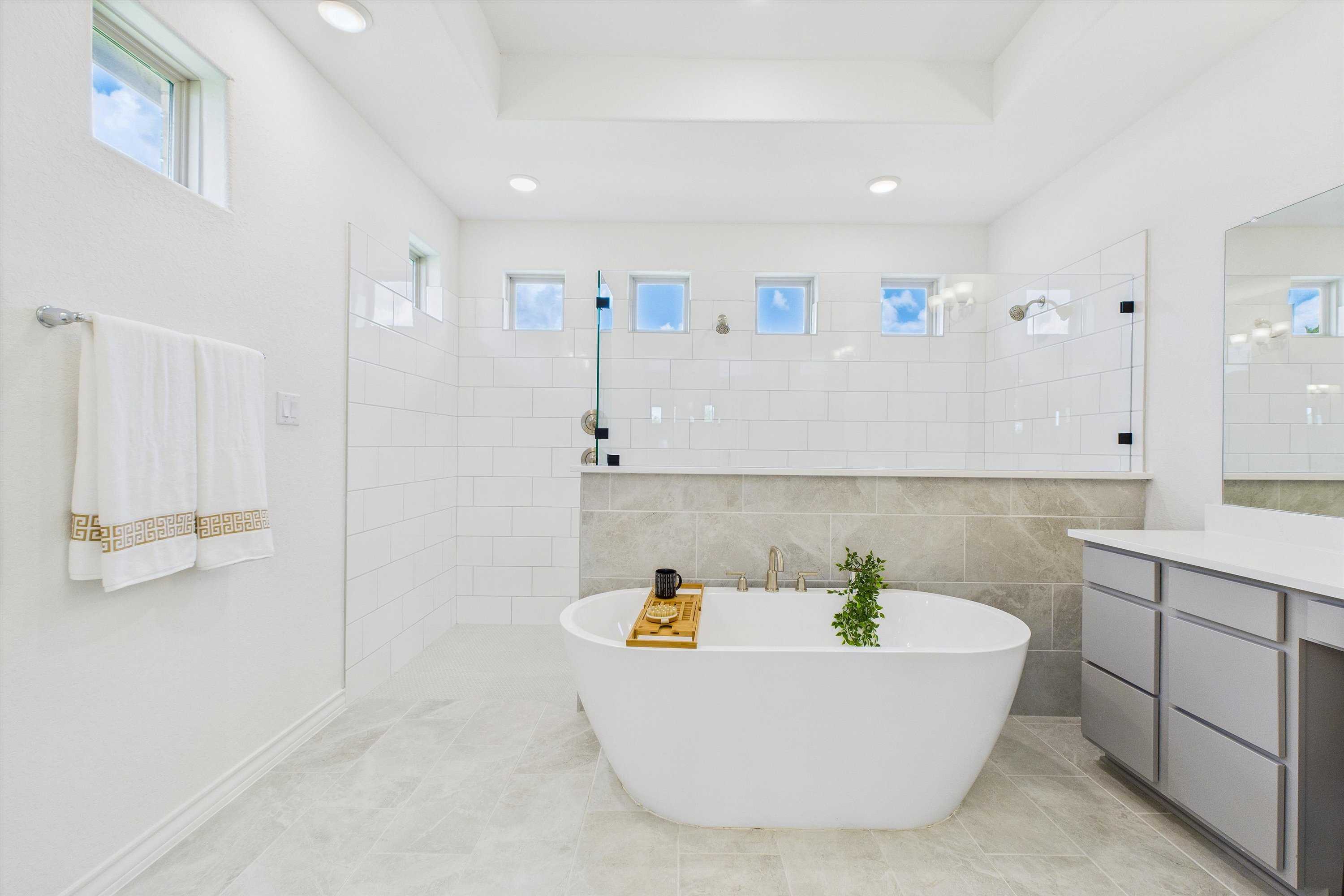 Luxurious master bathroom featuring freestanding tub, tiled walk-in shower, and modern vanity in Davidson Homes The Summerlin C, Castroville, Texas