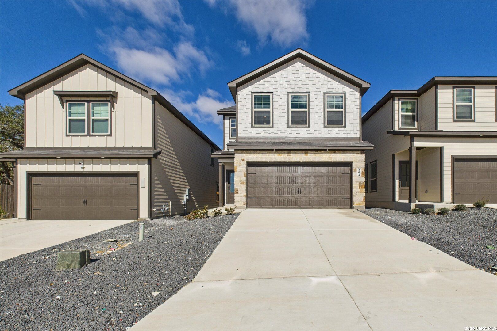 Modern two-story 4-bedroom home with stone accents, 2-car garage, and driveway in Meadows at Oak Creek, San Antonio, Texas by Davidson Homes