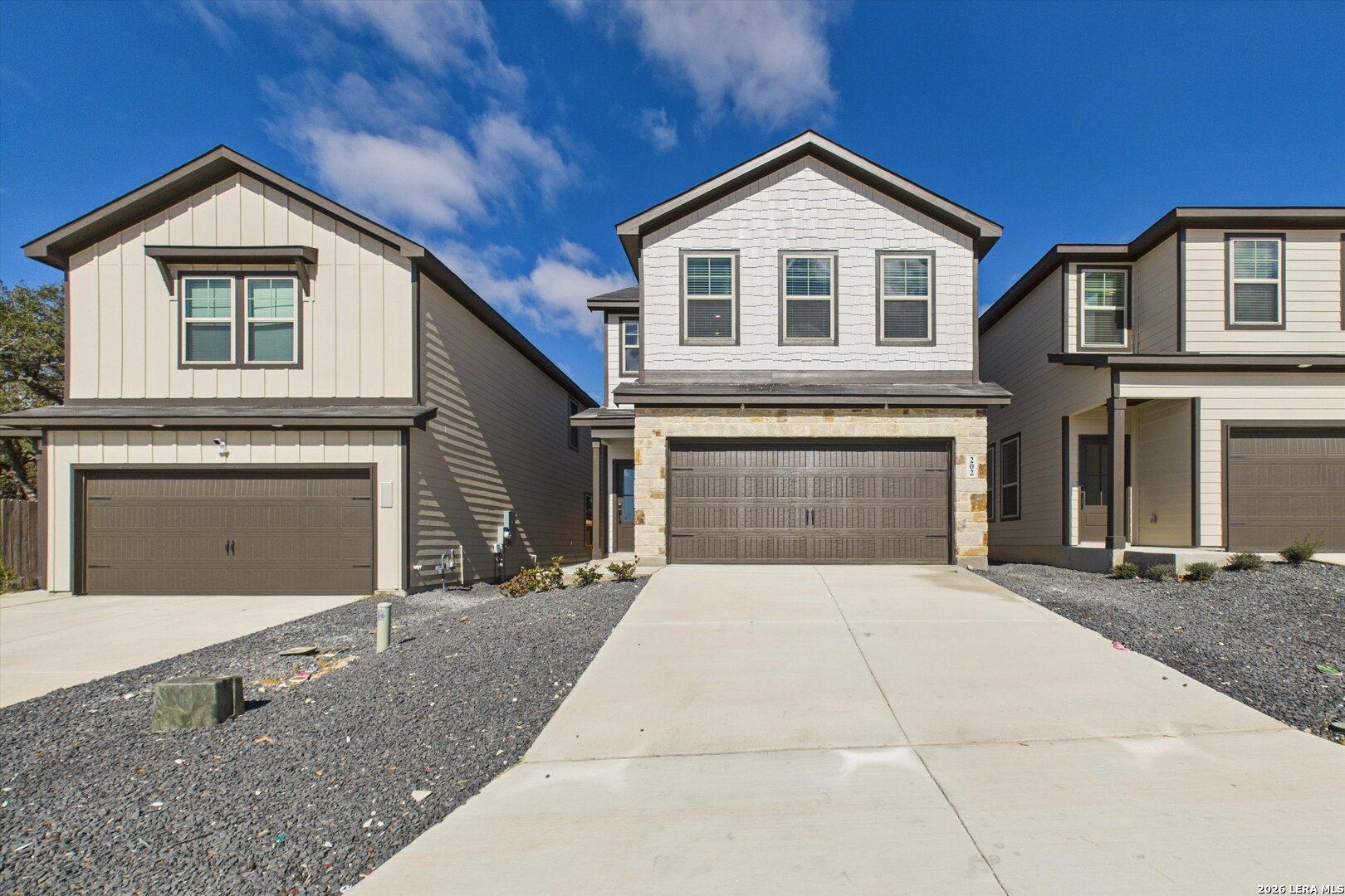 Modern two-story 4-bedroom home with stone accents, 2-car garage, and driveway in Meadows at Oak Creek, San Antonio, Texas by Davidson Homes
