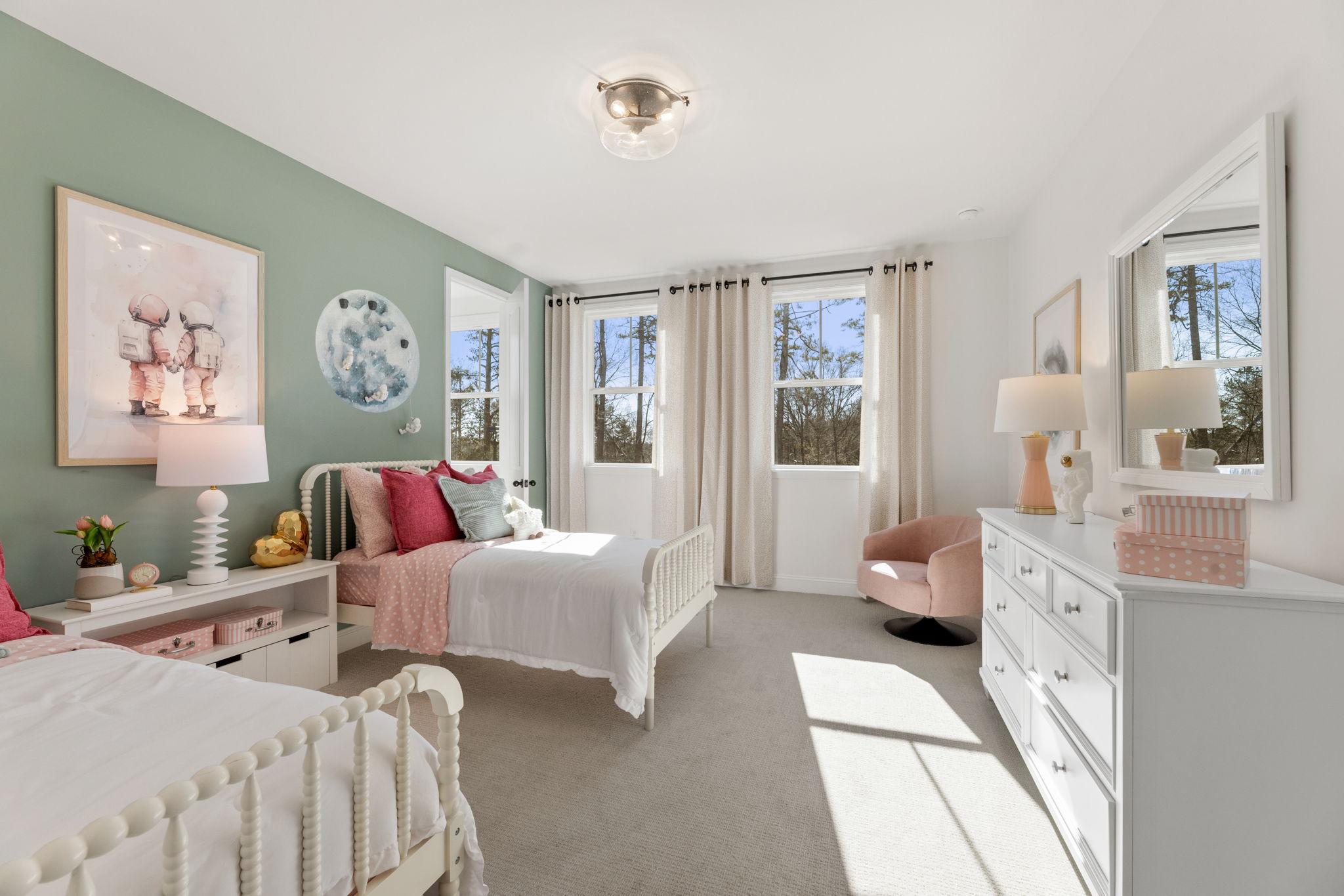 Charming girl's bedroom at Fern Hollow in Buford GA featuring mint green walls, pink bedding, white twin bed and large windows