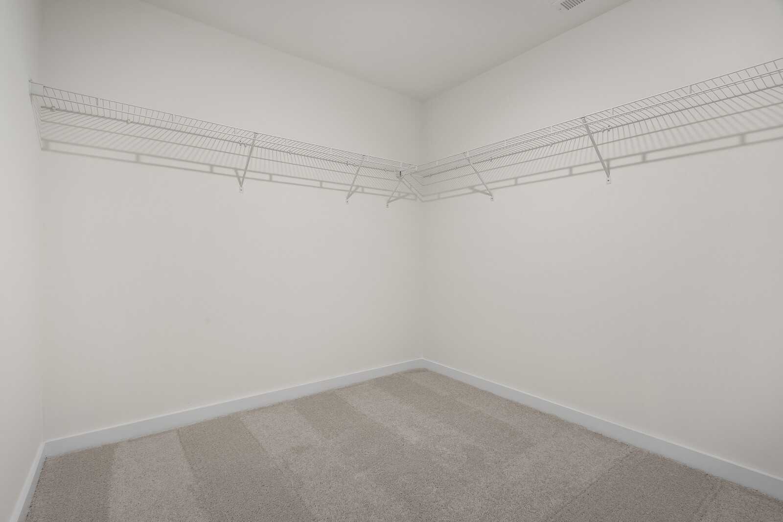 Spacious walk-in closet with wire shelving in master suite, The Logan C by Davidson Homes in Gallatin, Tennessee