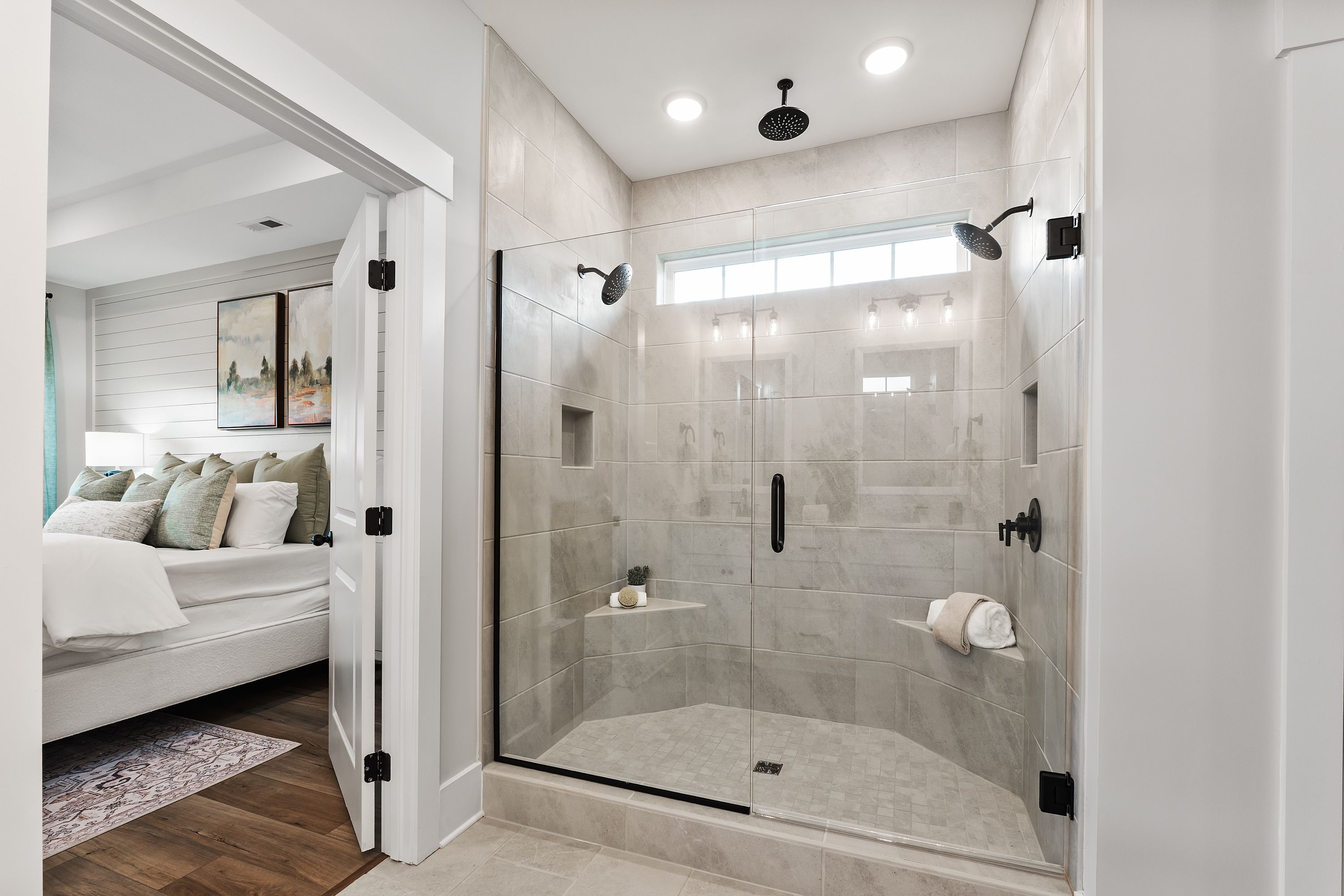 Spacious primary bathroom at River Road Estates in Decatur AL featuring frameless glass walk-in shower and subway tile