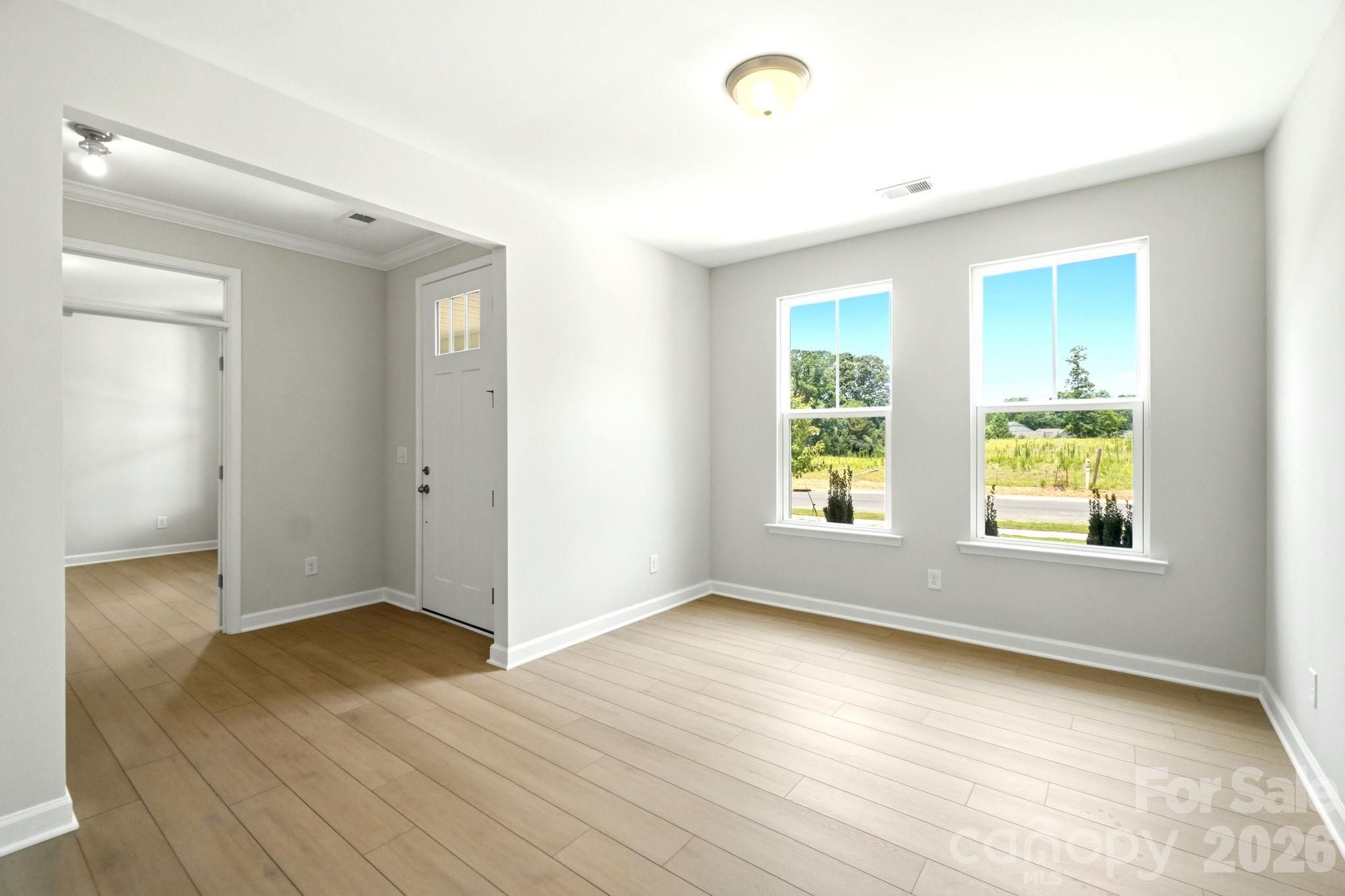 Bright, open entryway with light wood flooring in The Magnolia B floor plan at Windgate in Mooresville, North Carolina.