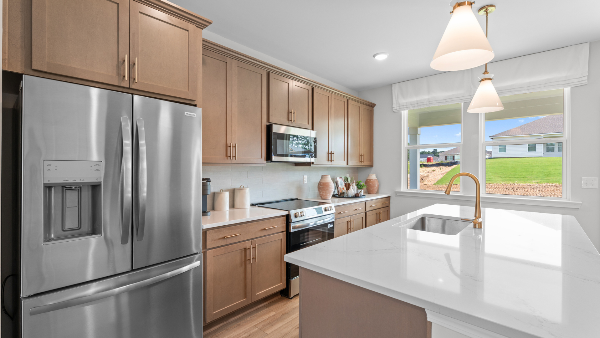 Modern kitchen in new Auburn home featuring premium stainless steel appliances and savings on 2-1 buydown mortgage rates.