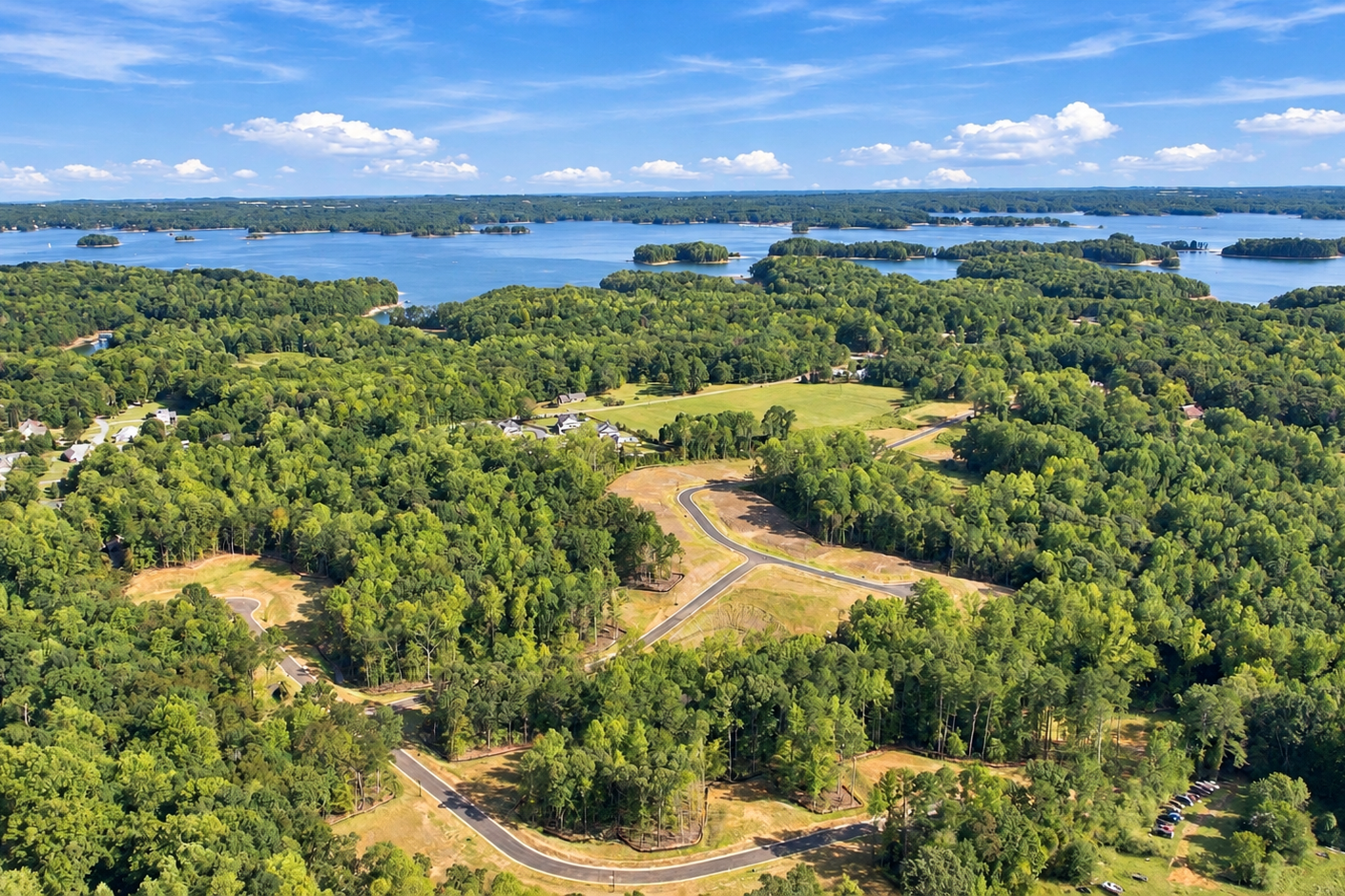 Aerial view of Lake Hollow community in Gainesville, Georgia with wooded homesites and curving streets near Lake Lanier