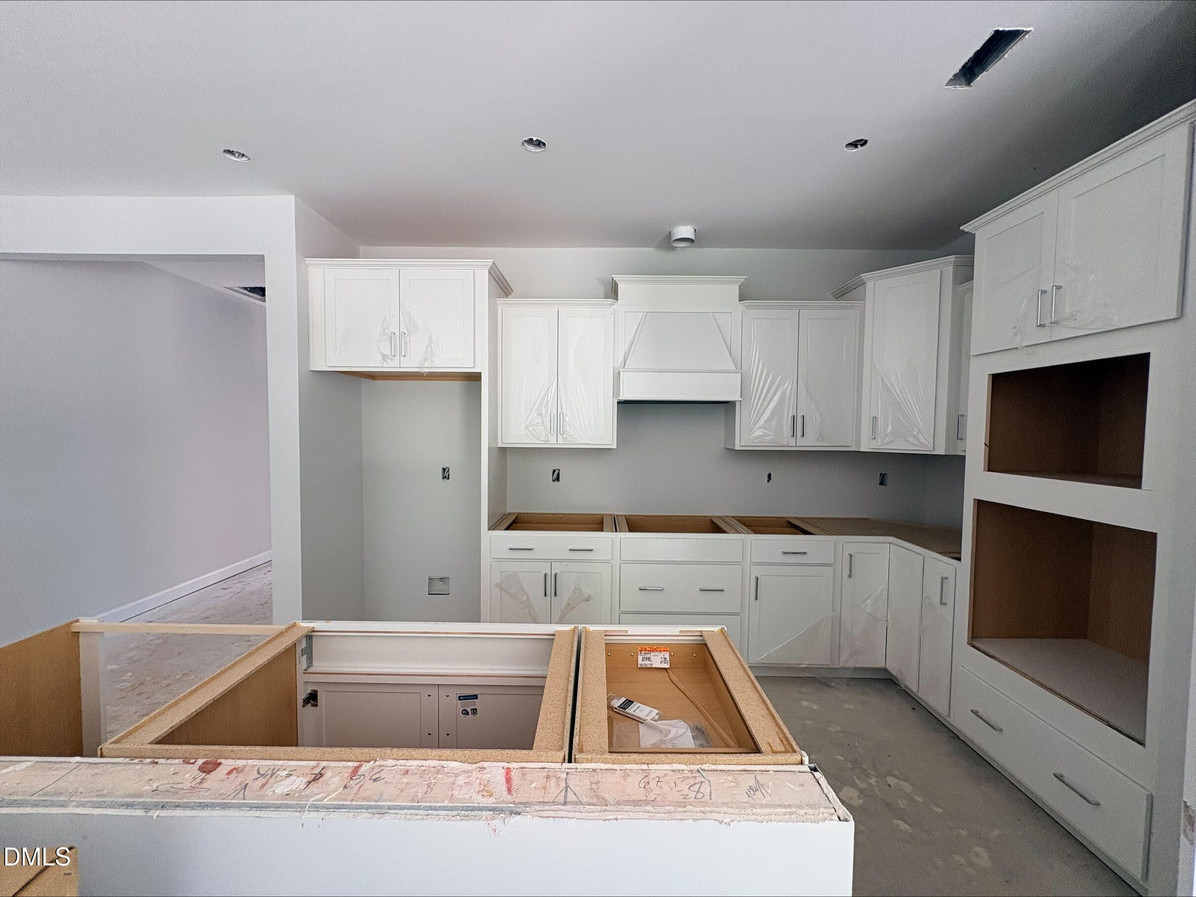 Modern white kitchen under construction in The Daphne D floor plan at Woodland Crossing in Zebulon, North Carolina.