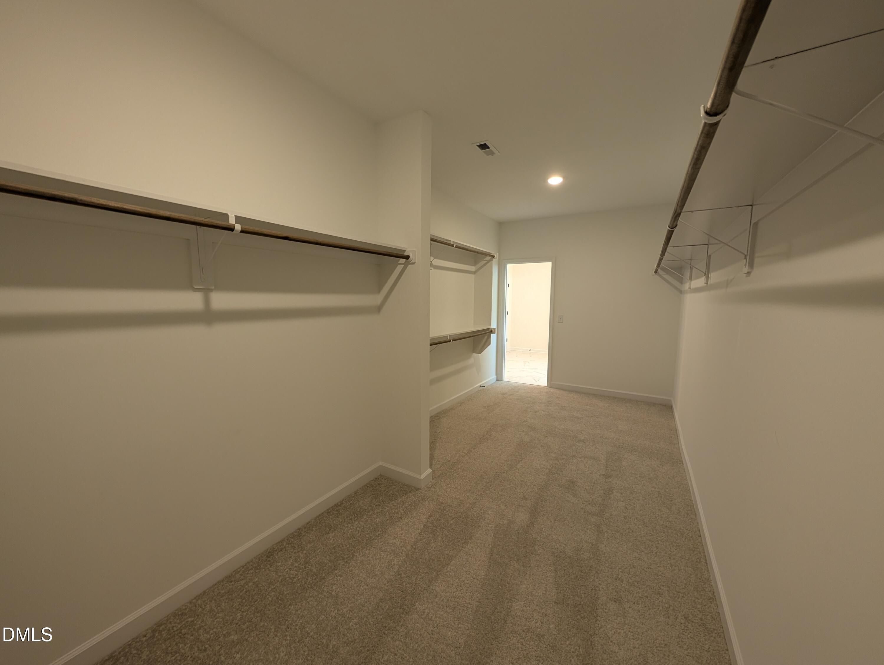 Spacious walk-in closet with custom shelving in The Aspen B floor plan at Wendell Ridge in Wendell, North Carolina.