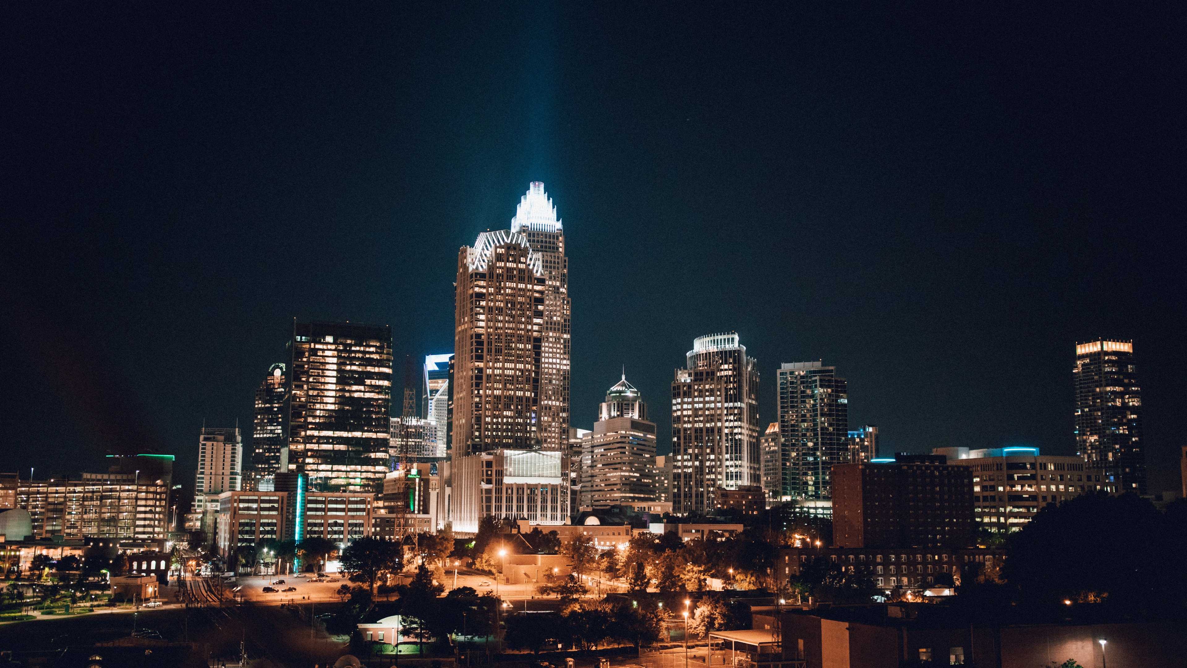 Vibrant Charlotte skyline at night with illuminated skyscrapers and city lights in the region
