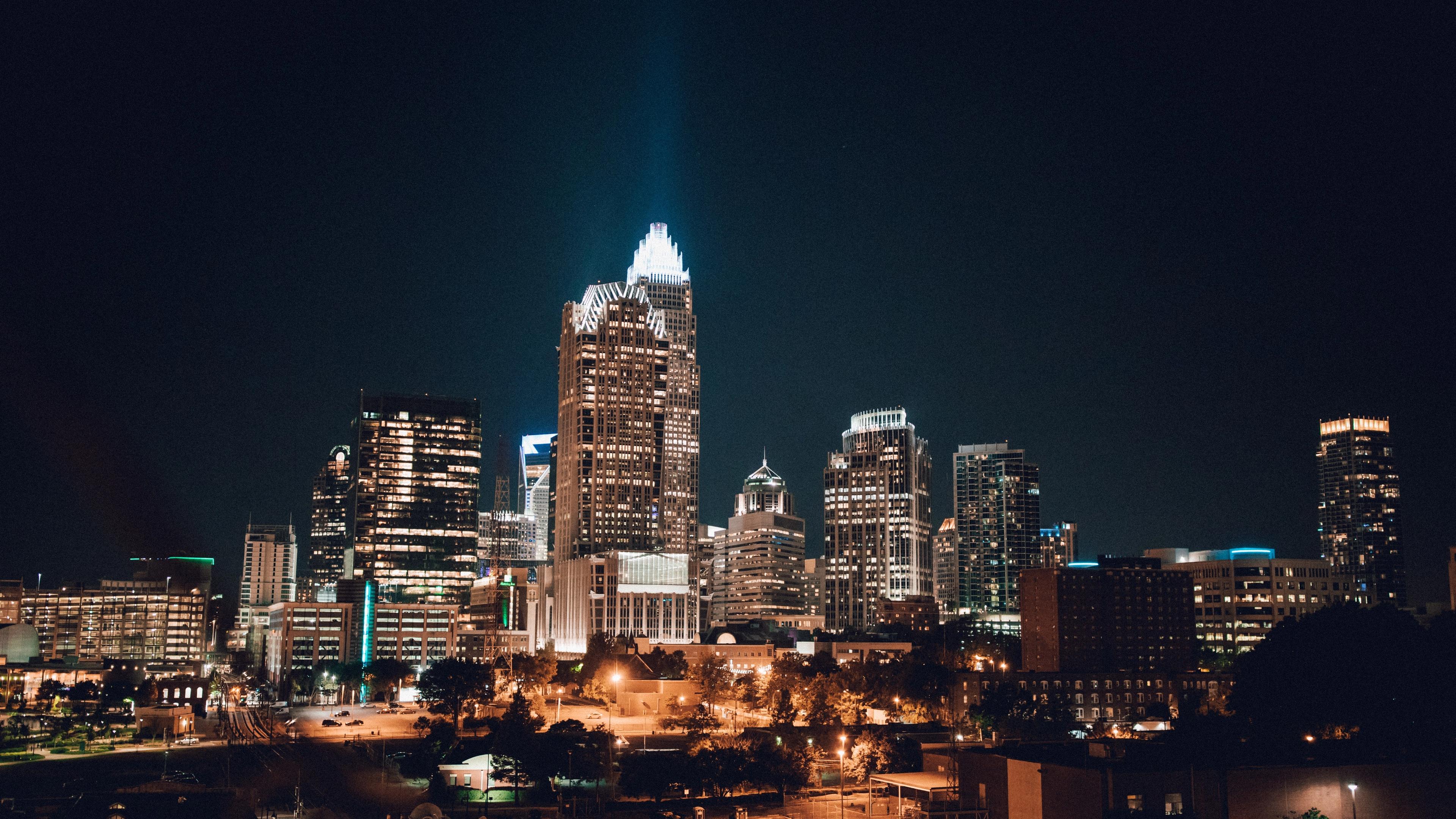 Vibrant Charlotte skyline at night with illuminated skyscrapers and city lights in the region